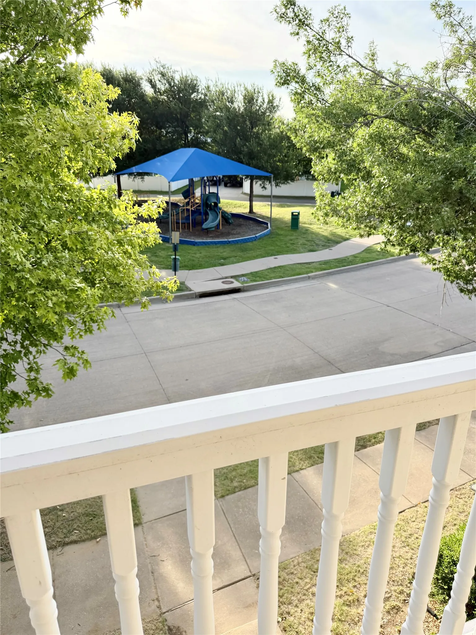 View of park from second story deck directly across from park with playground.