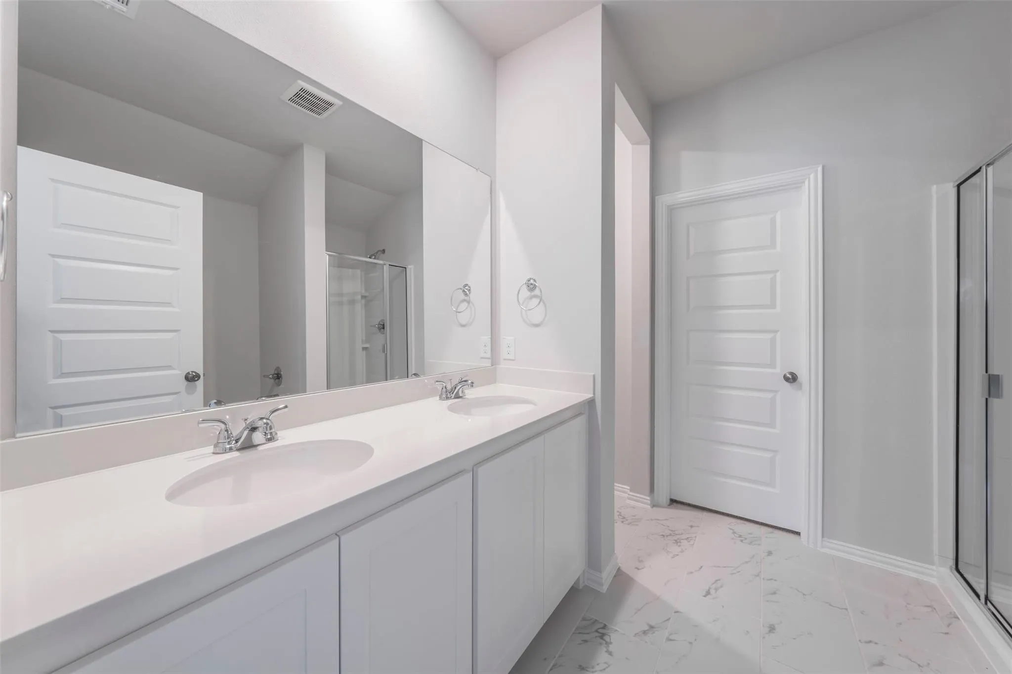 Double vanity featuring integrated sinks and chrome fixtures