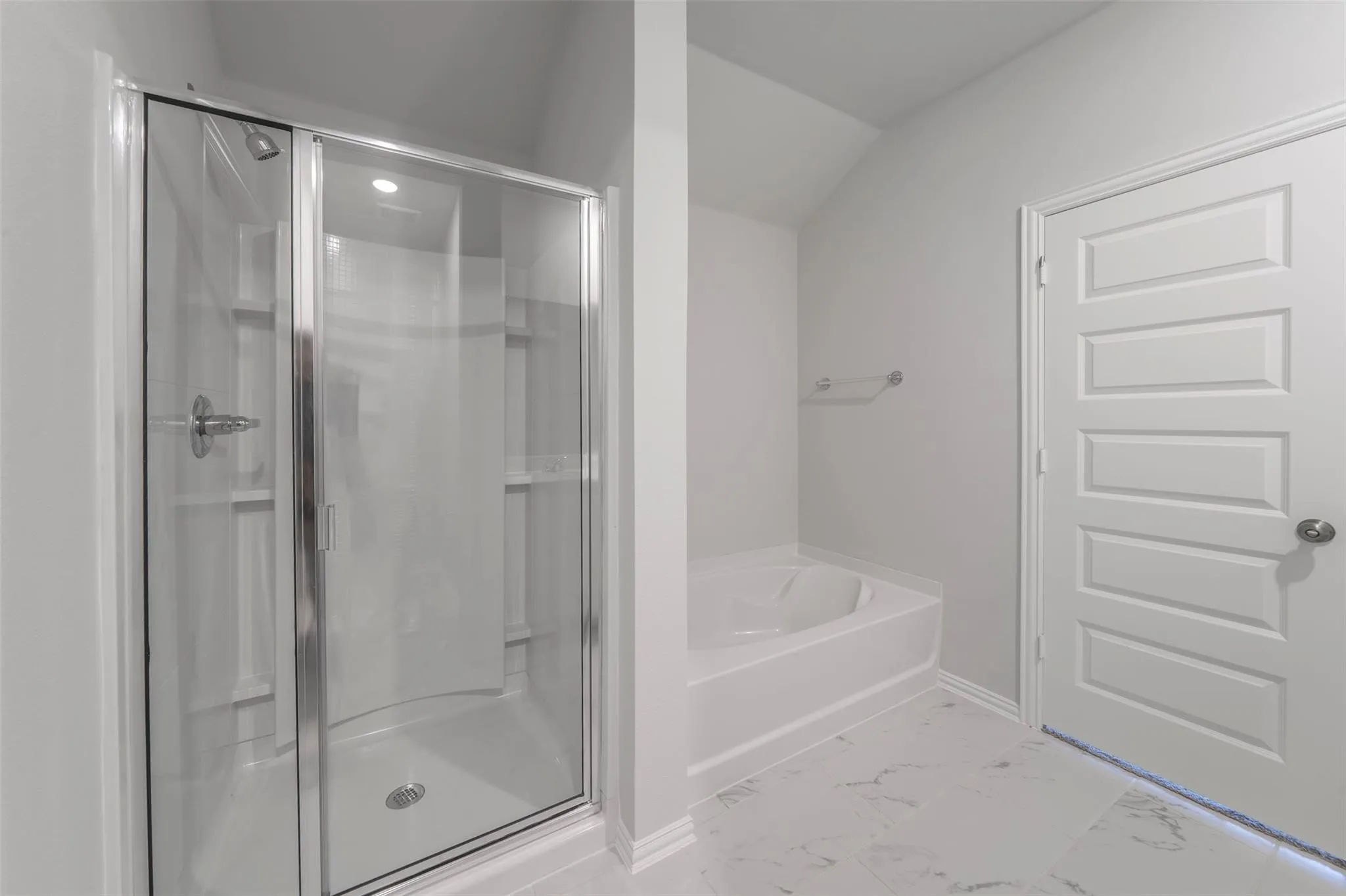 Walk-in shower with clear glass enclosure and chrome fixtures