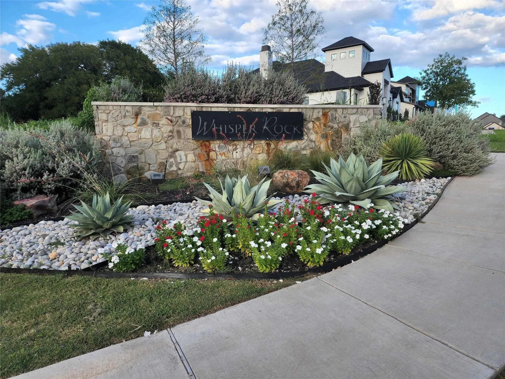 Stone-clad entry monument with integrated signage