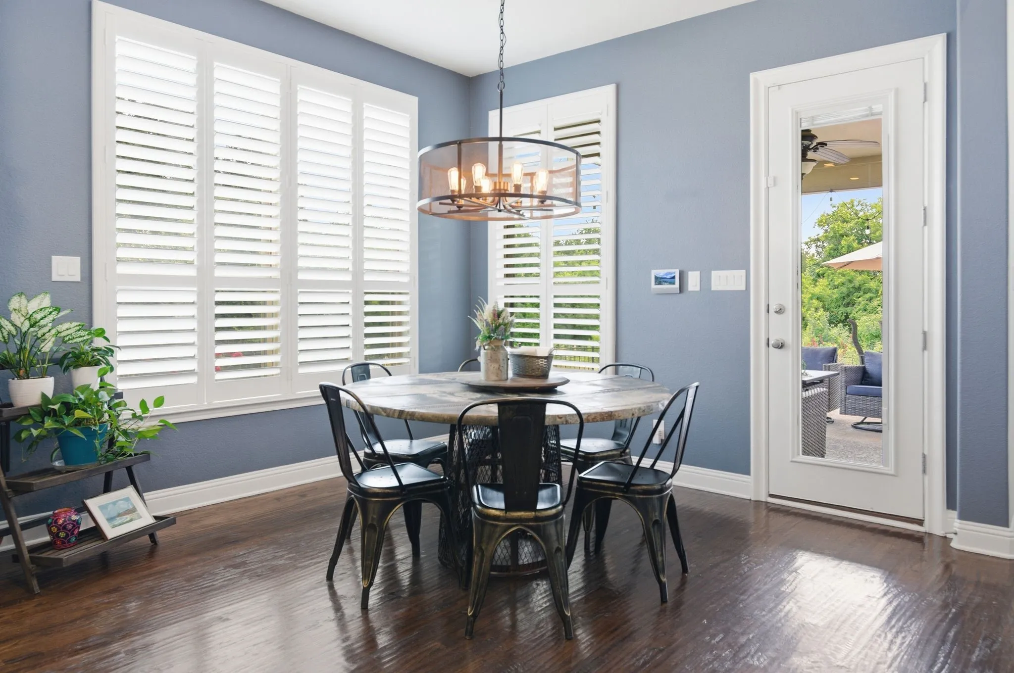 Dining area with rich wood-finish flooring and a full-light glass door leading to an outdoor space