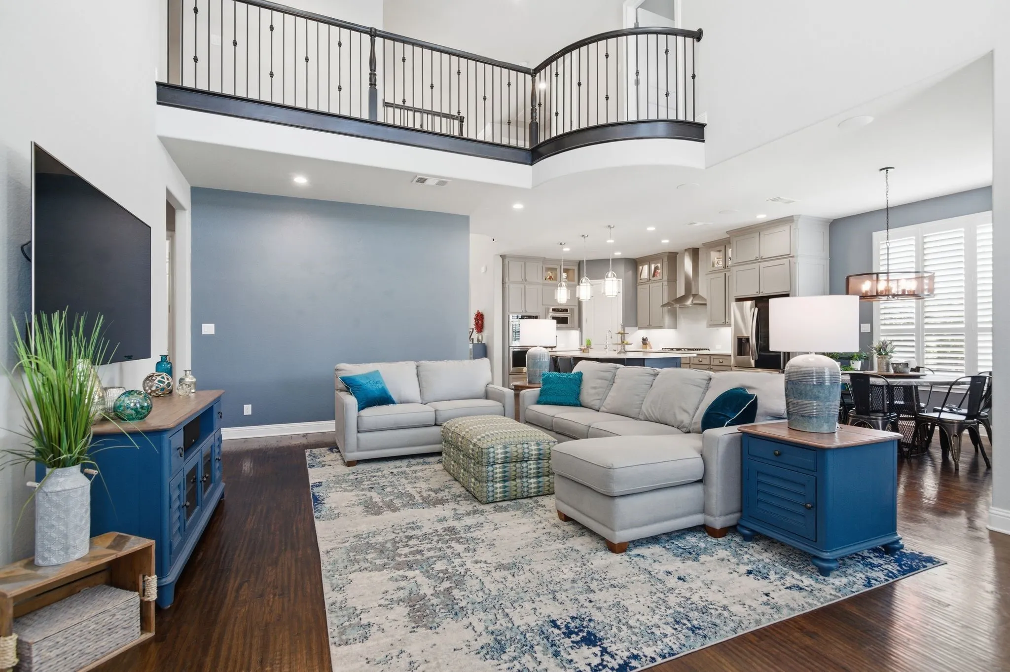 Spacious living area featuring high ceilings and dark wood-finish flooring