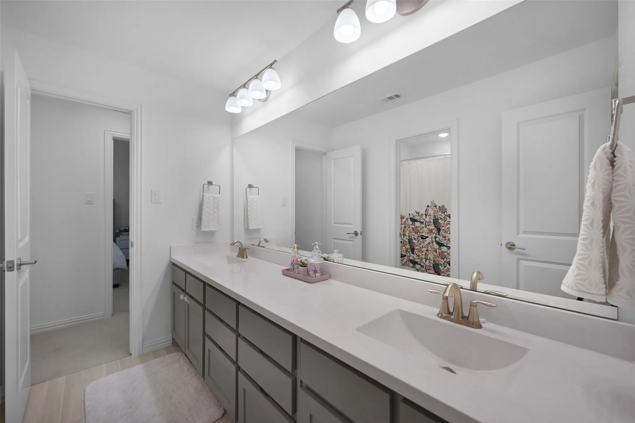 Dual vanity with integrated sinks, brushed nickel fixtures, and a spacious countertop