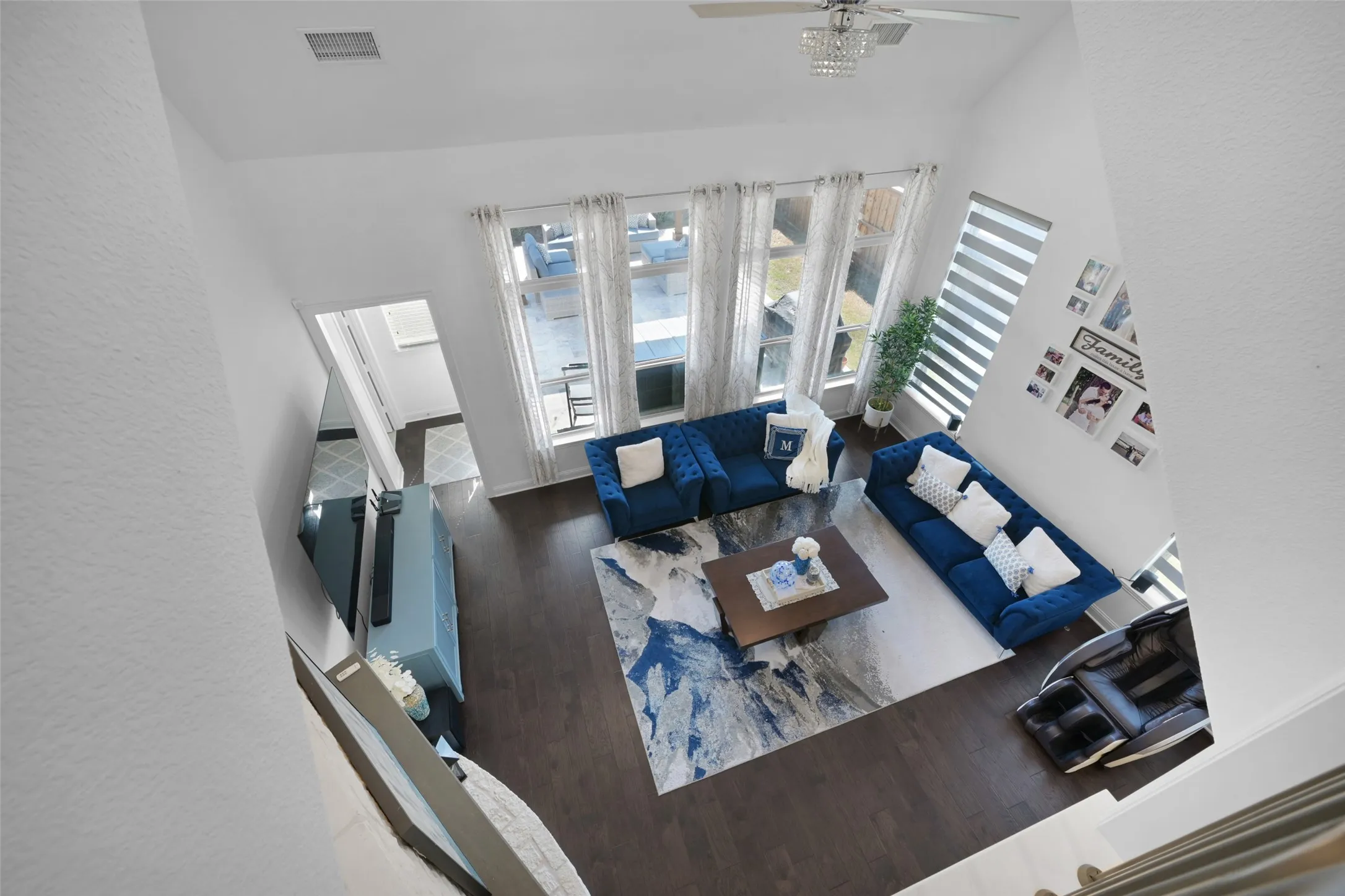 Spacious living area featuring a vaulted ceiling and dark wood-finish flooring