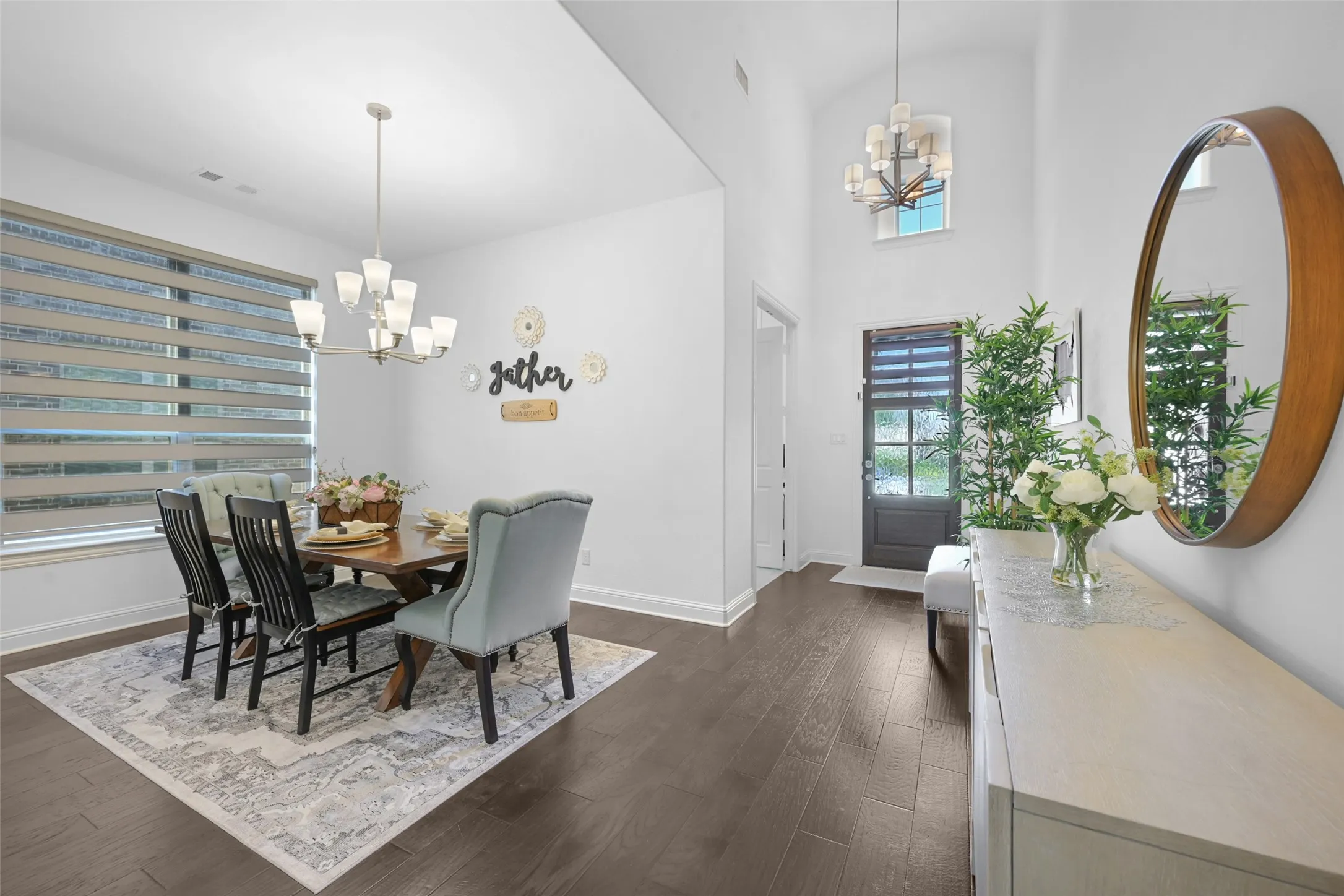 Entryway and dining area featuring dark wood-finish flooring
