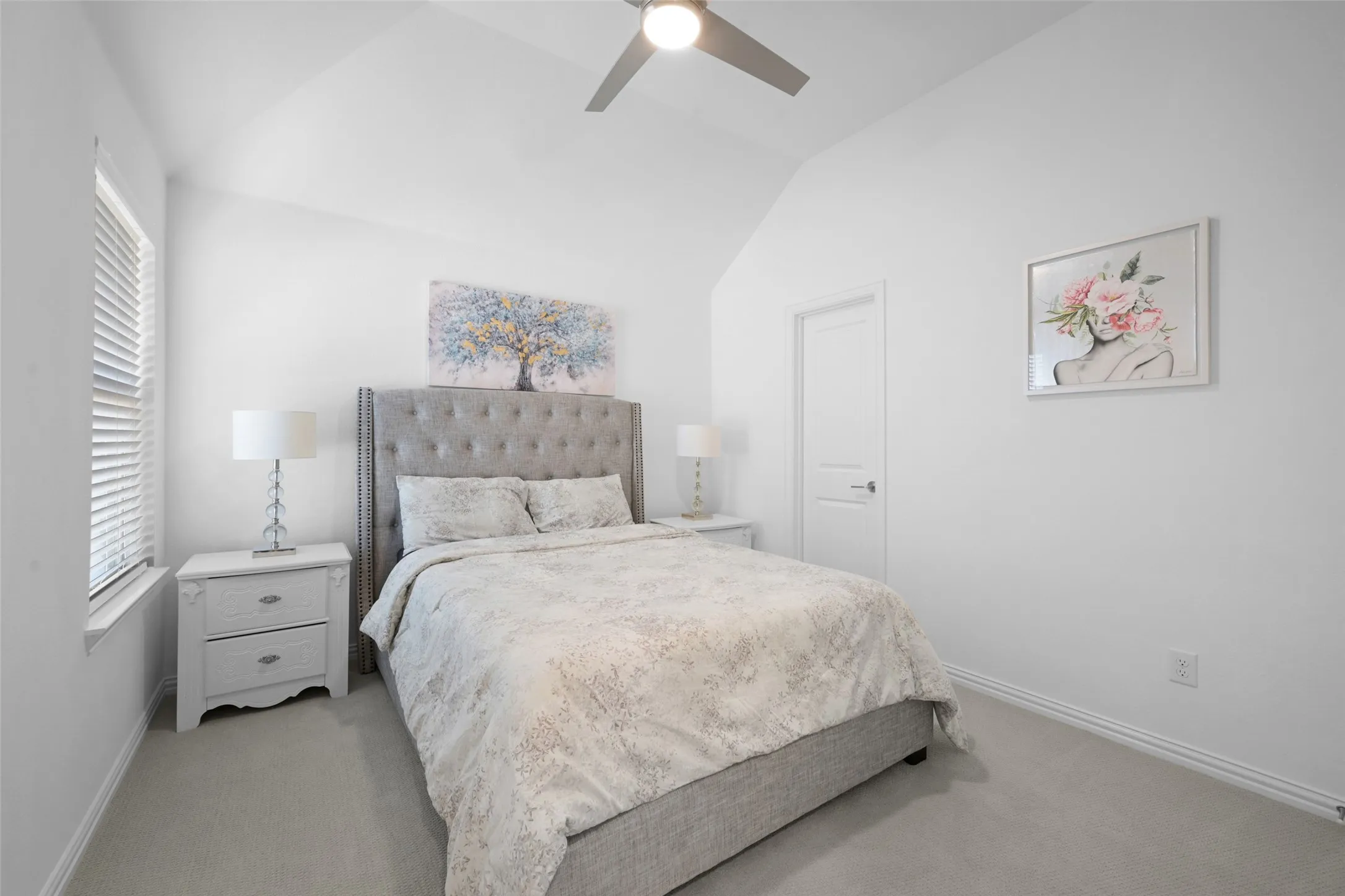 Bedroom featuring light-toned carpeting and vaulted ceilings