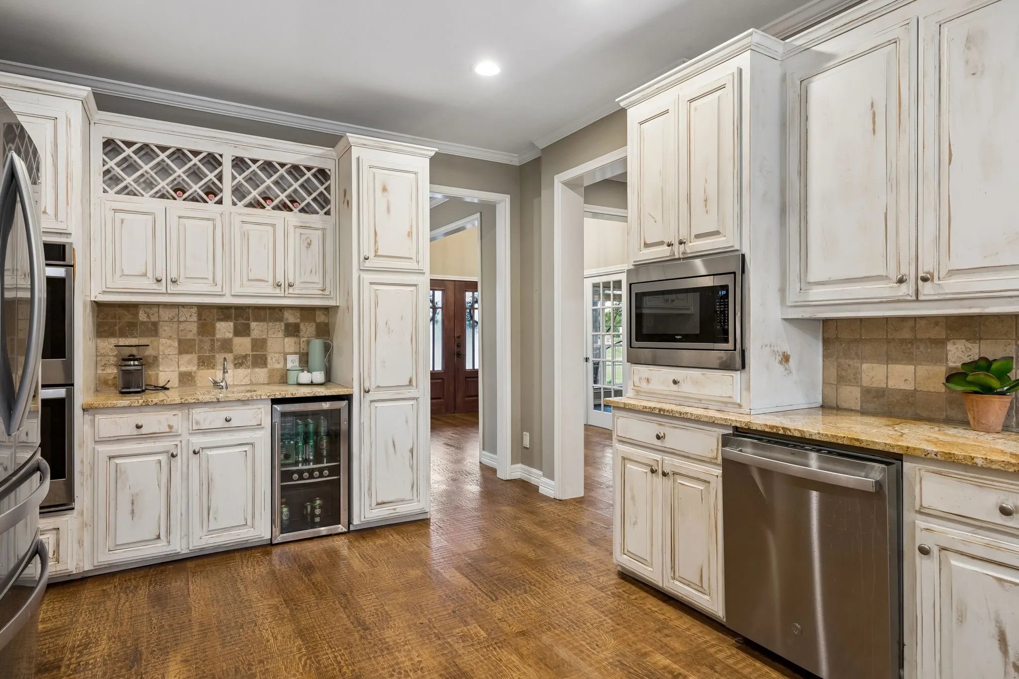 The kitchen is already spacious and functional, with stainless appliances, refrigerator and beverage frig, and coffee bar.