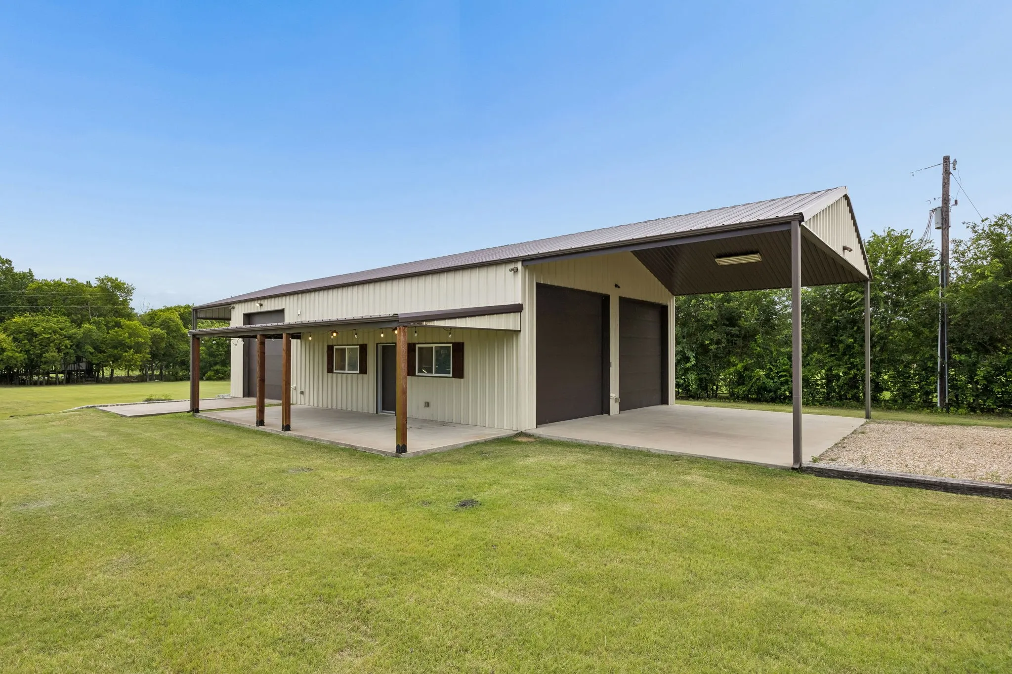 Calling it a workshop, but the possibilities are endless. 1600 sq ft with 3, 12 ft doors, electricity, and climate controlled. Great for car enthusiasts, hobbyists, boat or RV lovers. The exterior porch overlooks the entire acreage