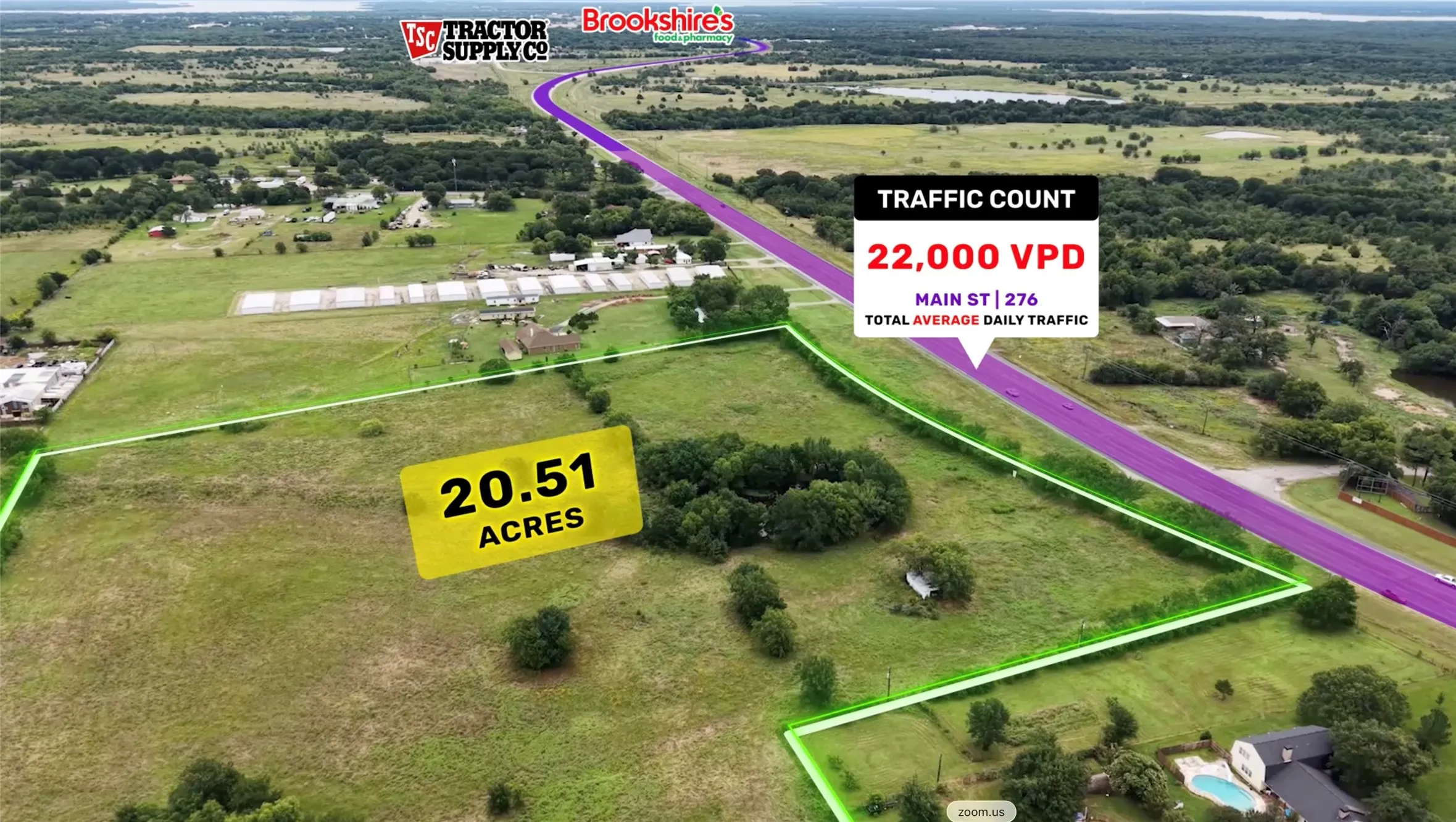 Expansive 20.51-acre property bordered by a major roadway, featuring mature trees and open green spaces