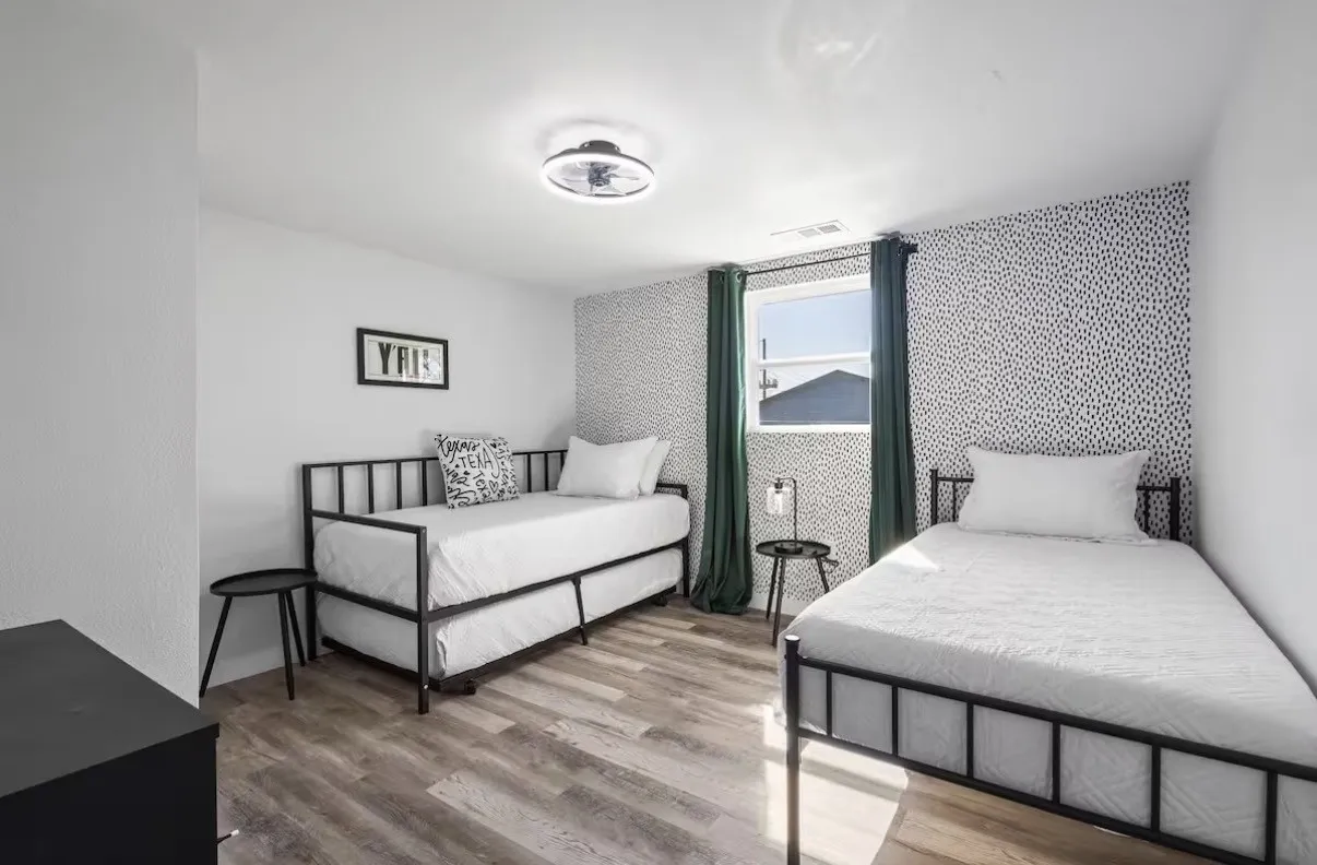 Versatile room featuring wood-finish flooring, a patterned accent wall, and recessed lighting with a ceiling fan