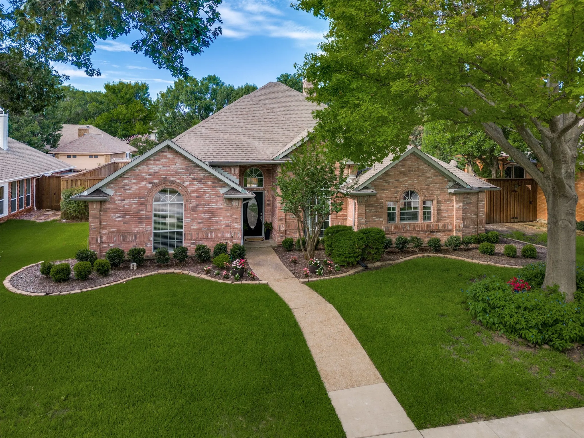 Brick exterior featuring a gabled roof and arched windows