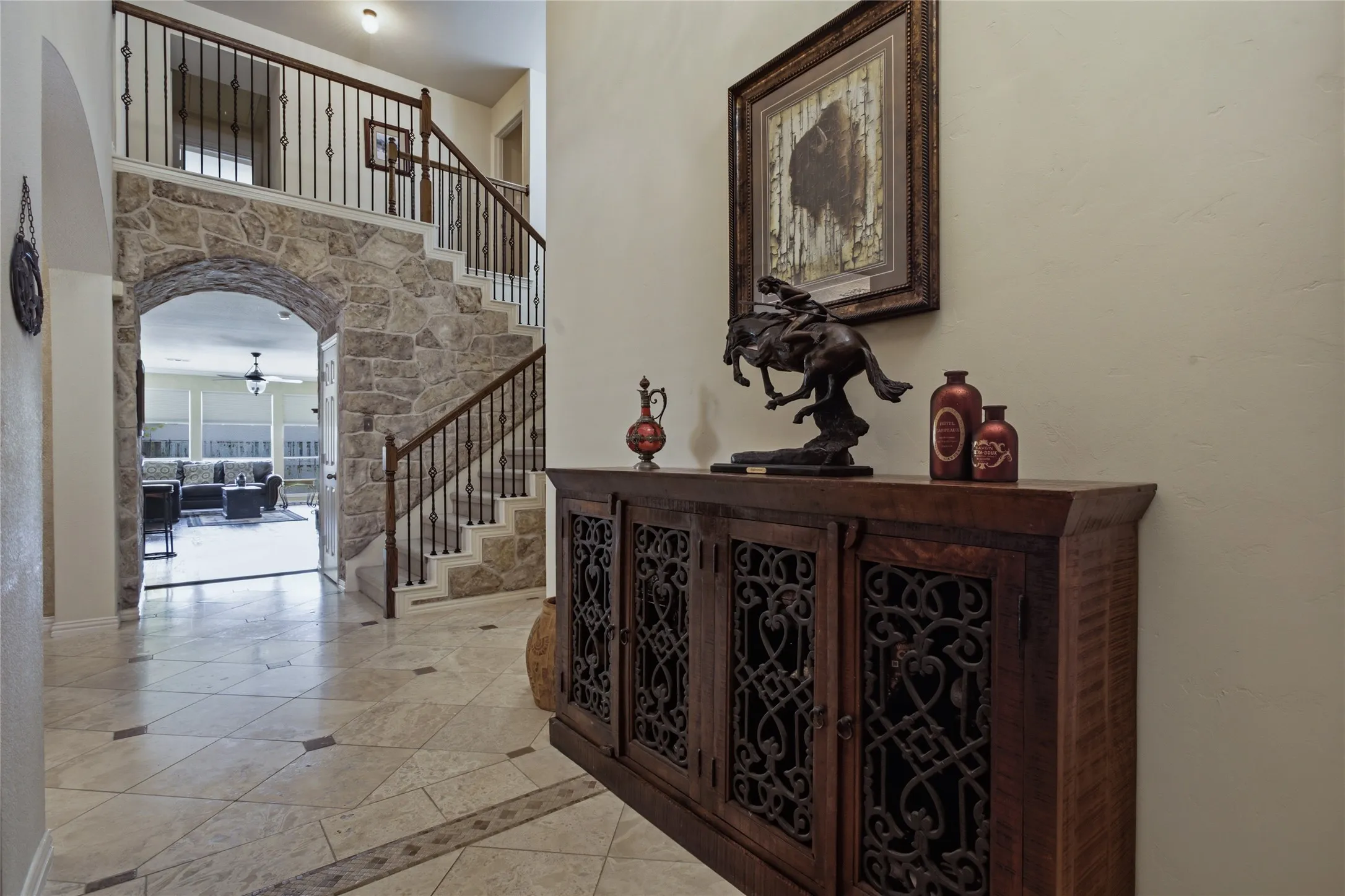 Soaring entryway featuring custom stonework around staircase.