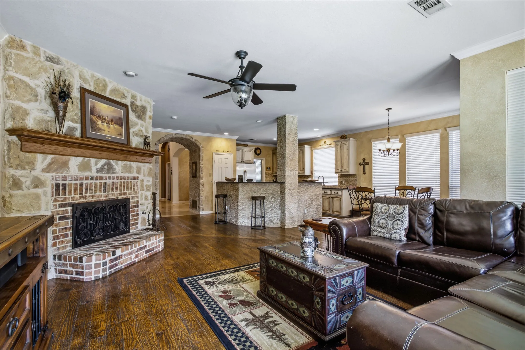 Floor to ceiling stone fireplace. Hardwood floors