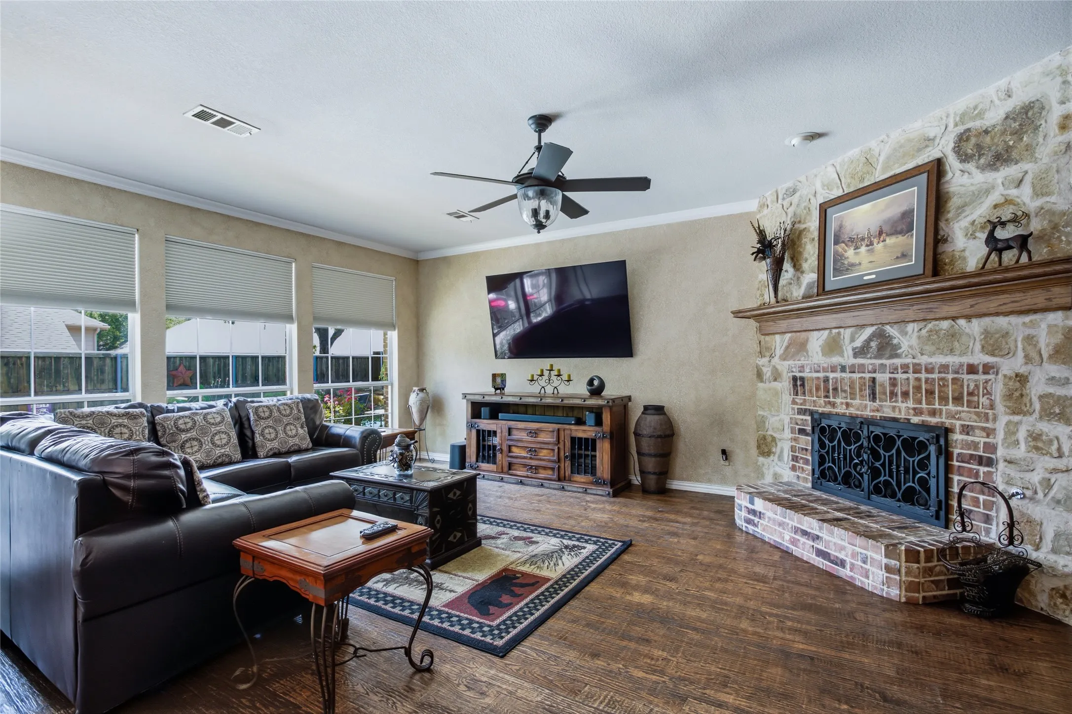 Floor to ceiling stone fireplace. Hardwood floors