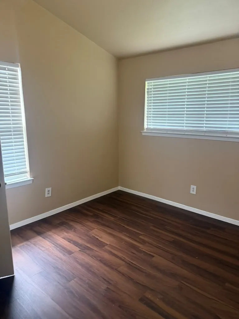 Neutral-toned walls complement wood-finish flooring