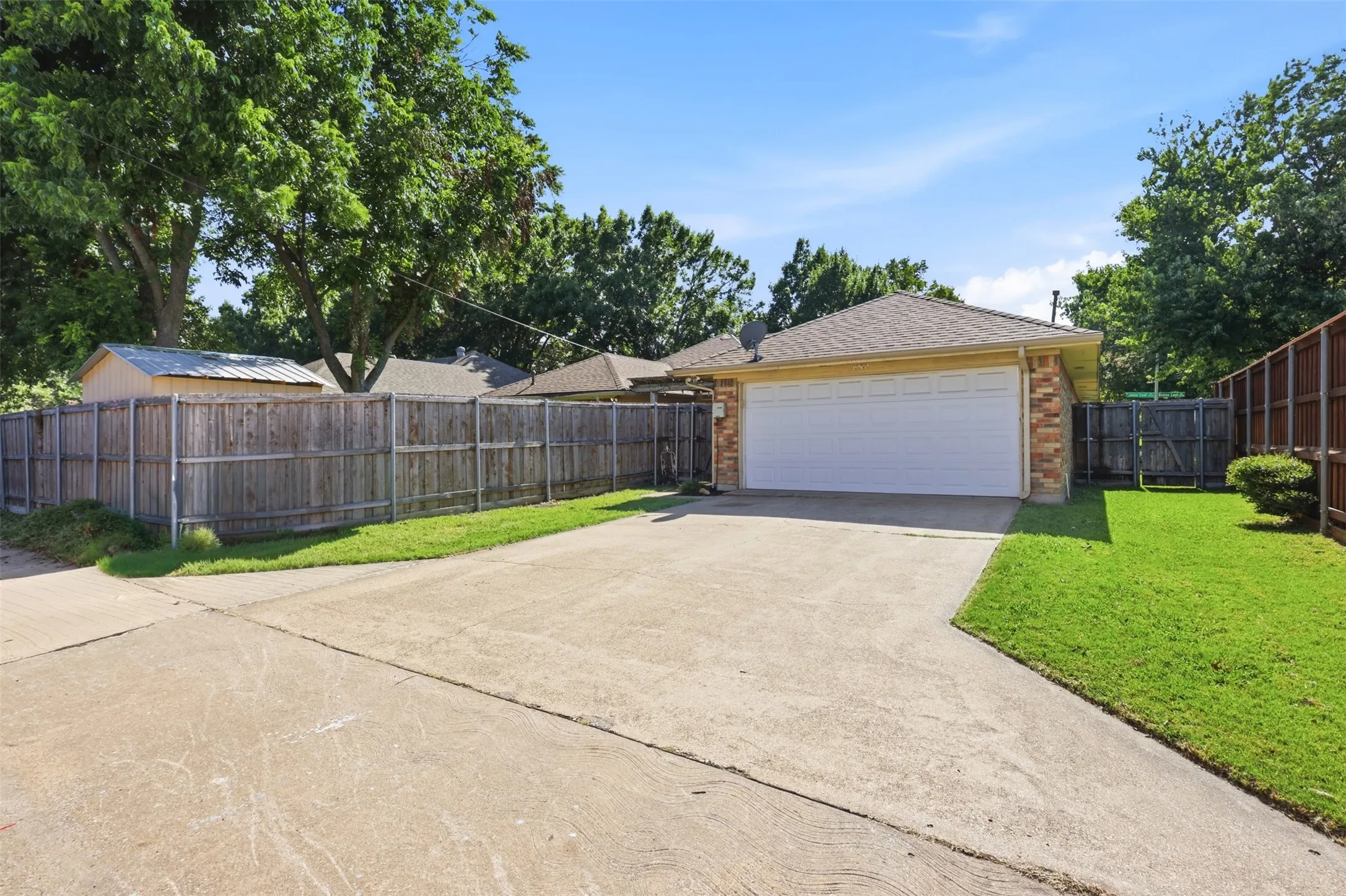 Concrete driveway leading to a two-car garage with an automatic door