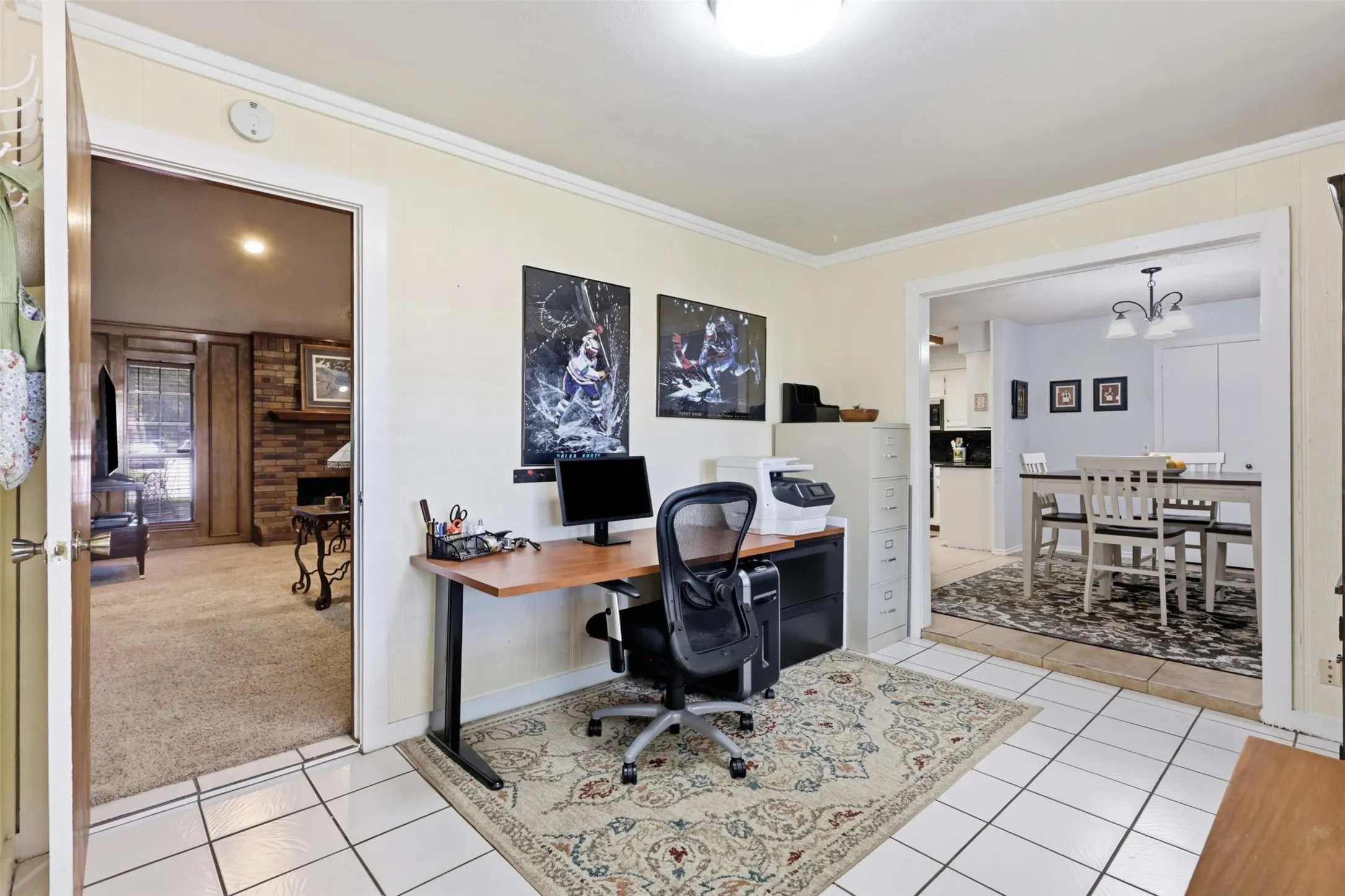 Versatile room featuring white tile flooring, crown molding, and a neutral wall palette
