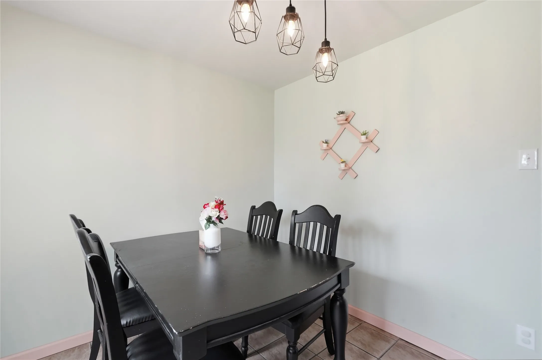 Dining area featuring light green walls and ceramic tile flooring