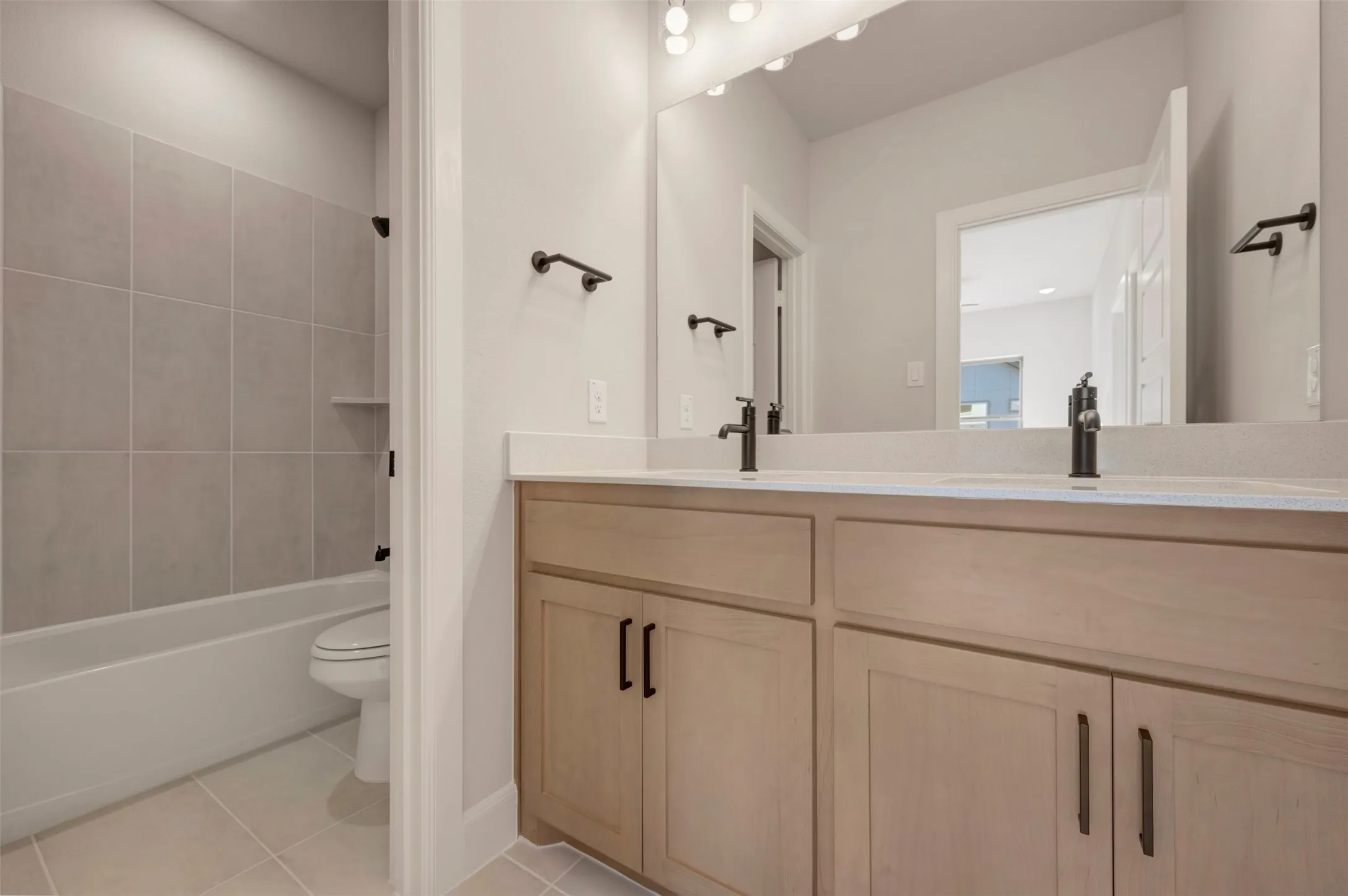 Dual vanity with wood-finish cabinetry and black hardware