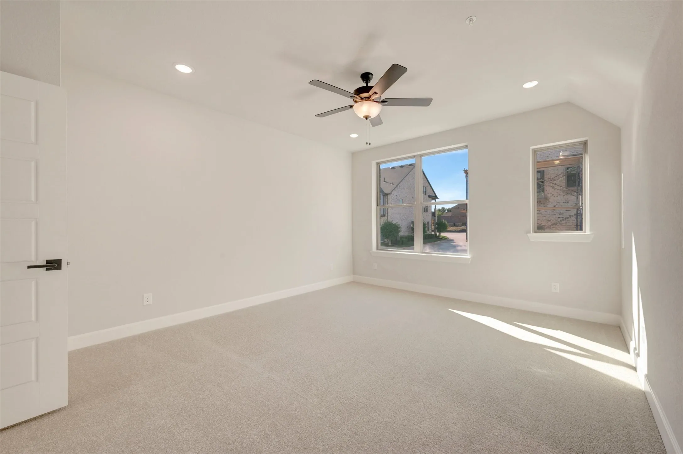 Vaulted ceiling with recessed lighting and ceiling fan