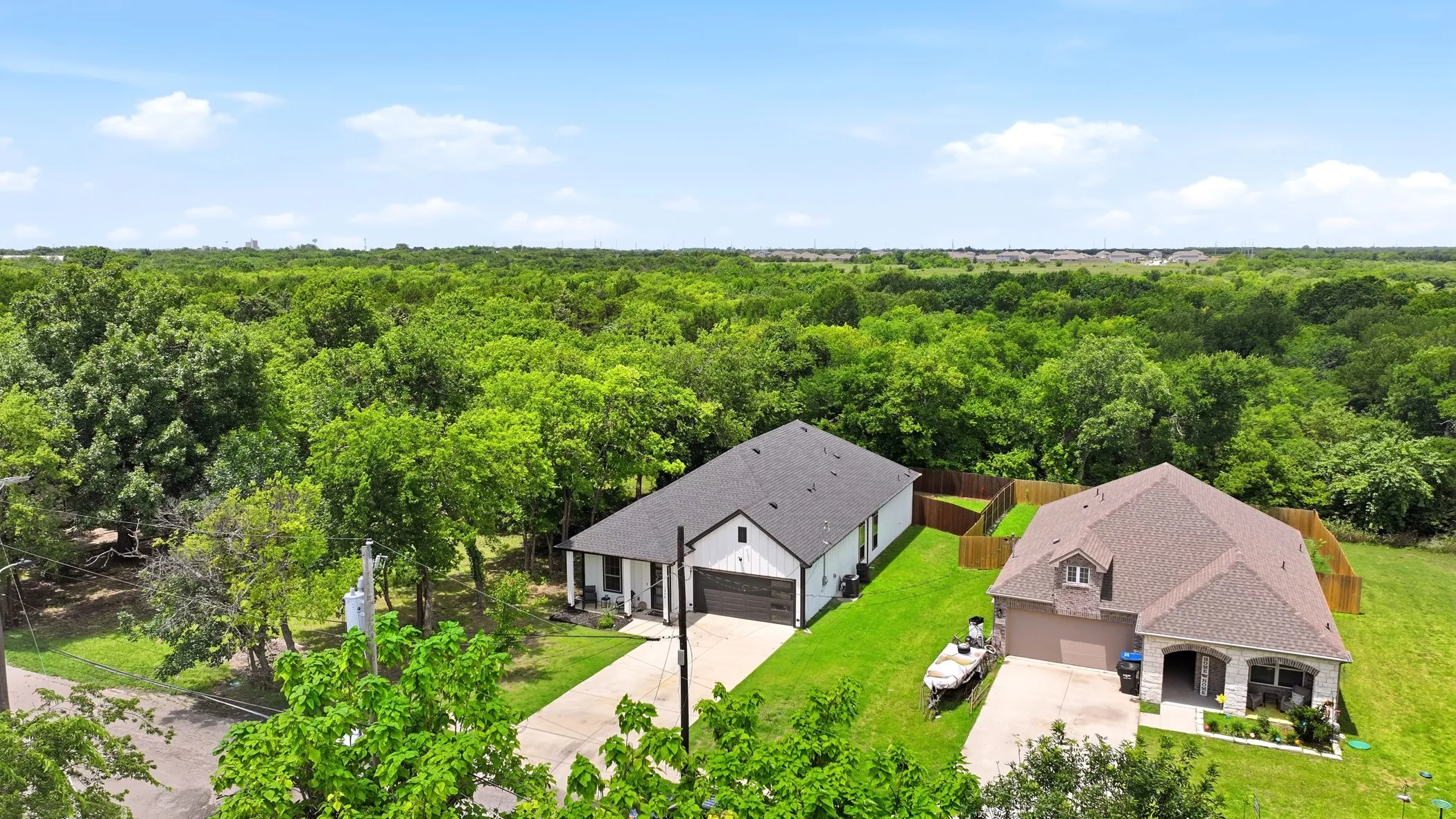 Contemporary single-story residence featuring a dark shingle roof and white siding