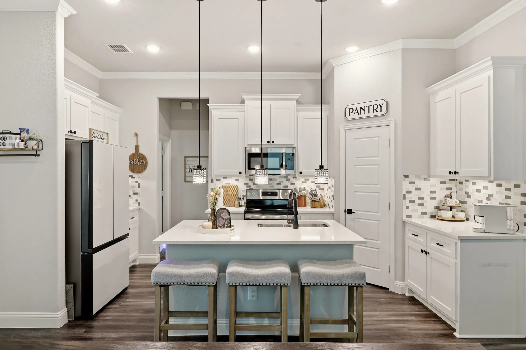 Dining area featuring wood-finish flooring, multiple windows, a rear glass-paneled door, recessed lighting, and crown molding