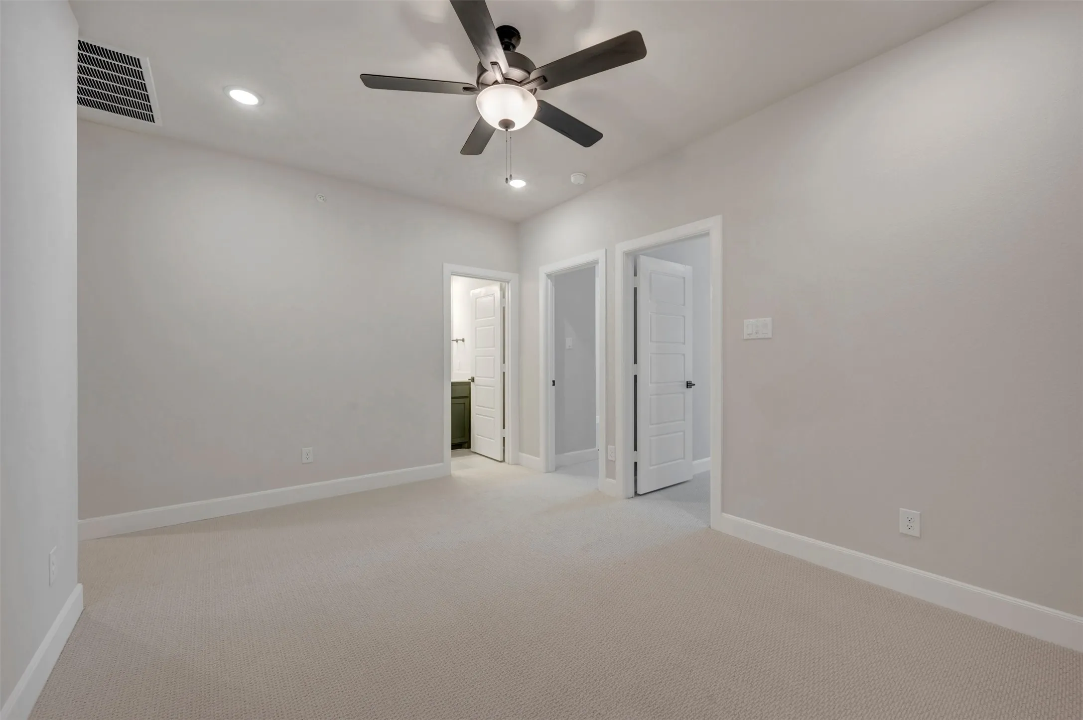 Plush carpet flooring, recessed ceiling lighting, and a ceiling fan with integrated light