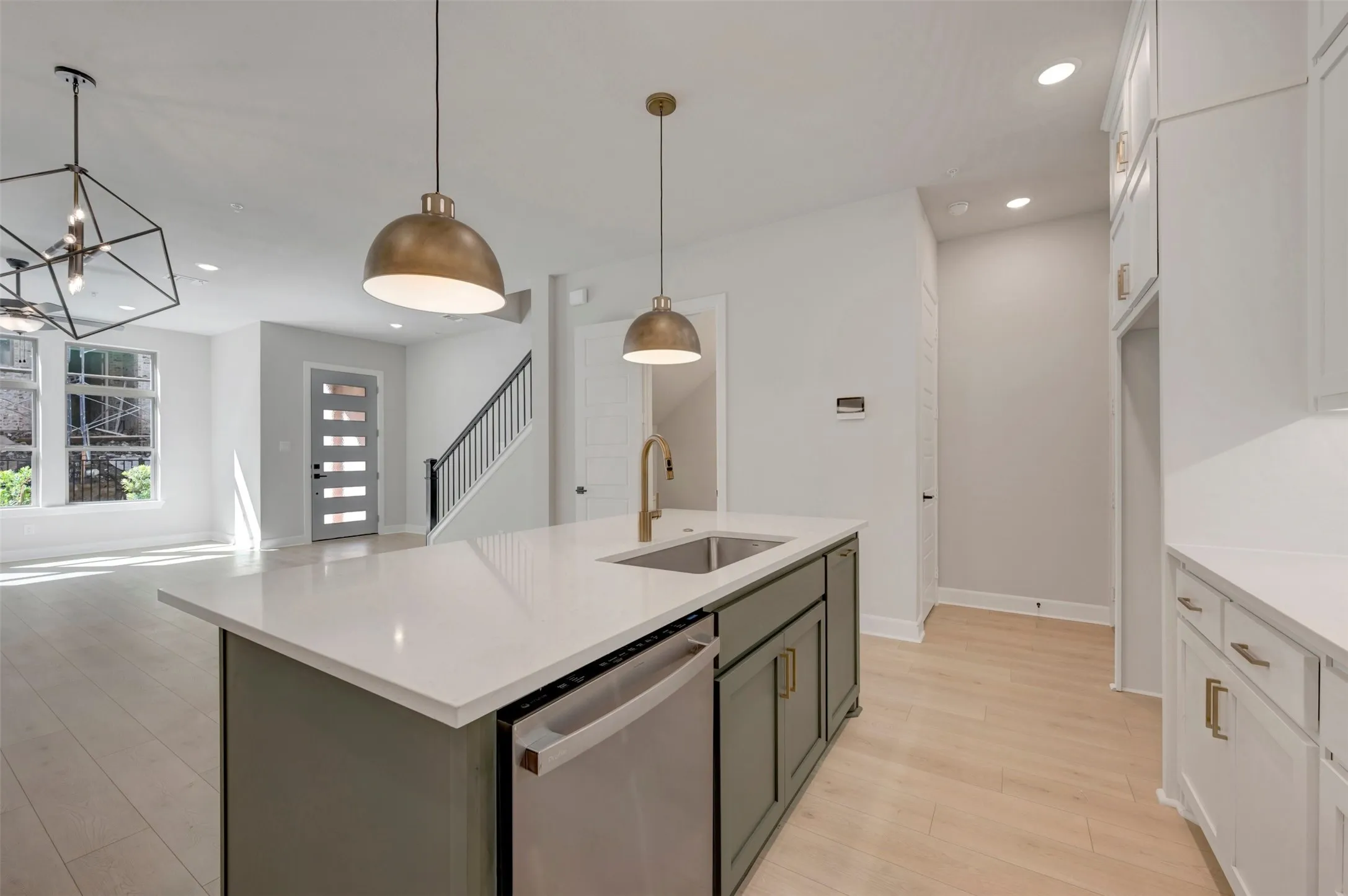 Open-concept living space with light wood-finish flooring