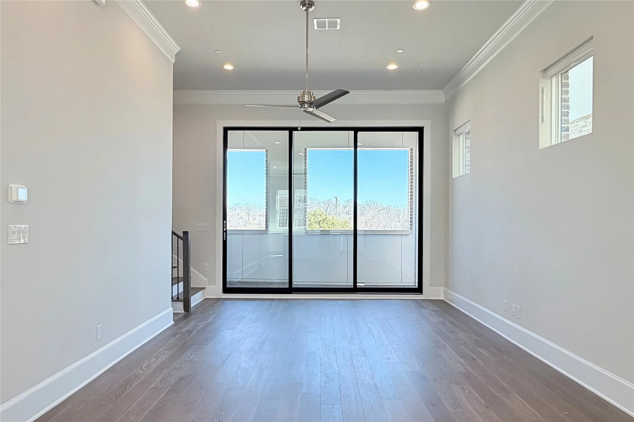 Progress photo of actual unit. 12' ceilings, 10' sliding glass patio doors leading to private balcony.