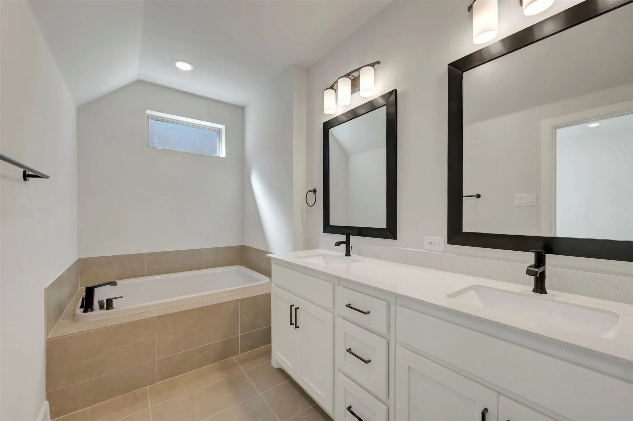 Dual vanities with white cabinetry, square undermount sinks, and matte black fixtures