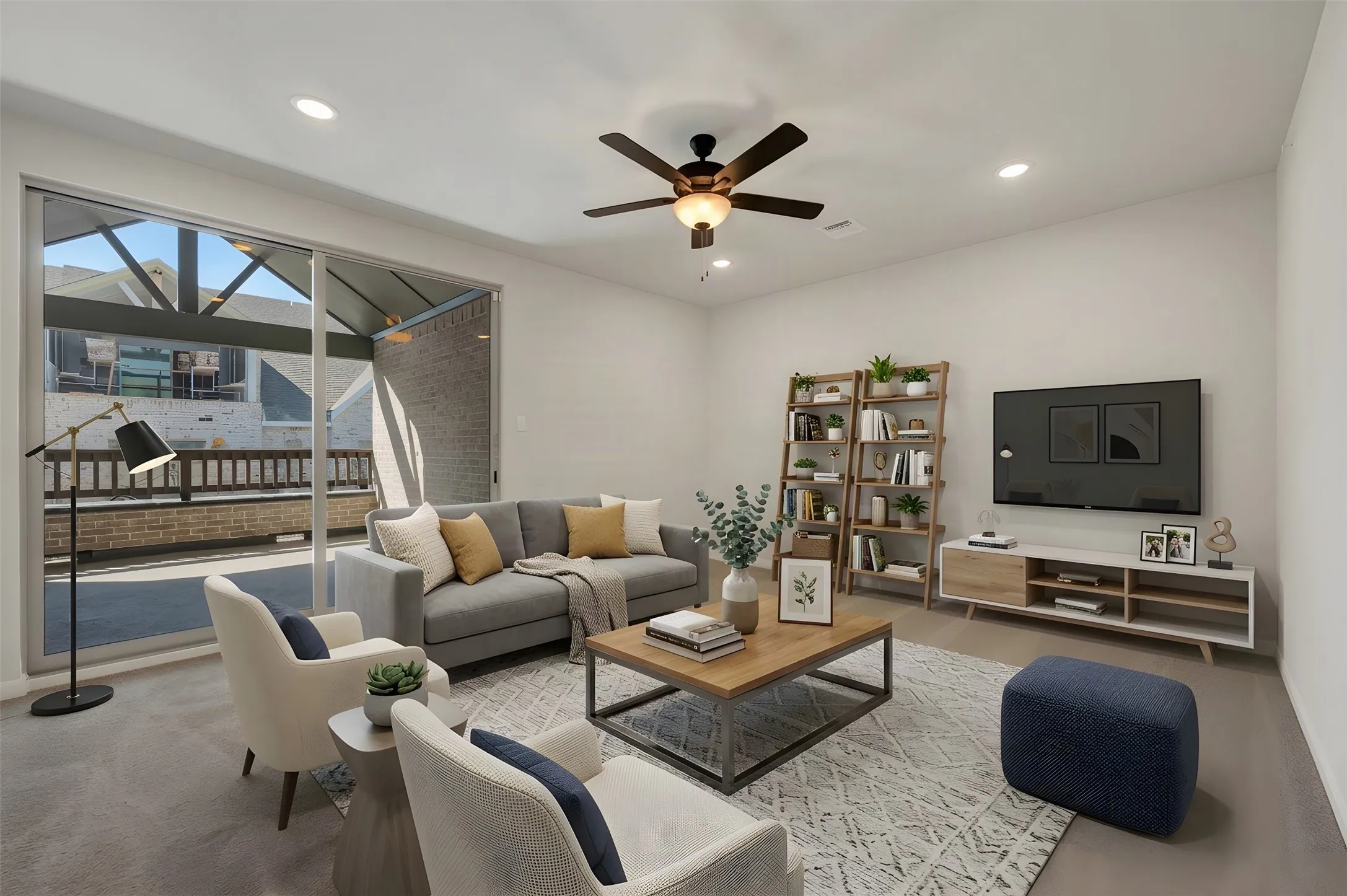 Recessed lighting, ceiling fan, and sliding glass door leading to an outdoor patio with a partial awning
