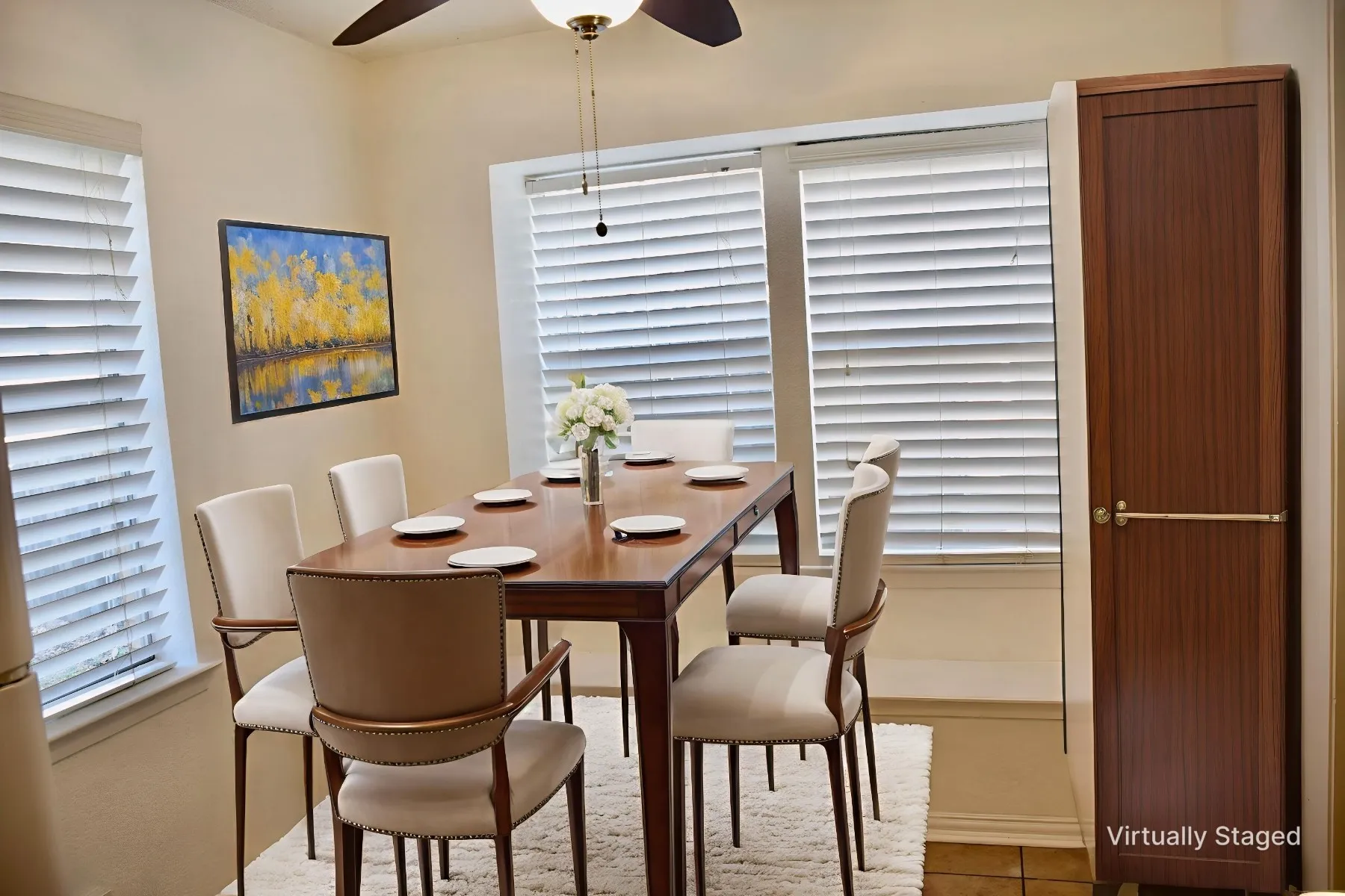 Dining area featuring multiple windows with blinds, a ceiling fan with integrated lighting, and tile flooring