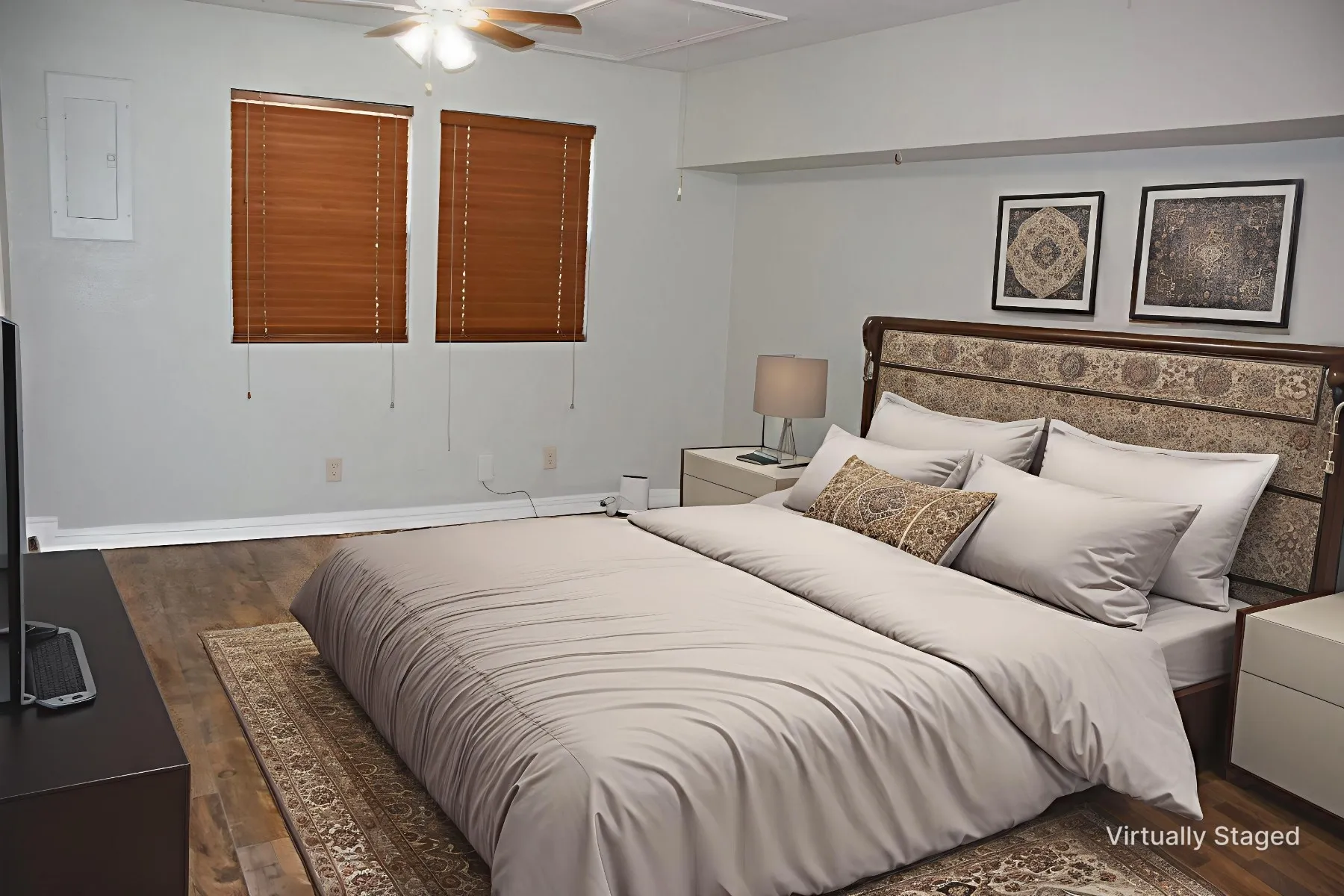 Bedroom featuring wood-finish flooring, two windows with horizontal blinds, and a ceiling fan with integrated lighting