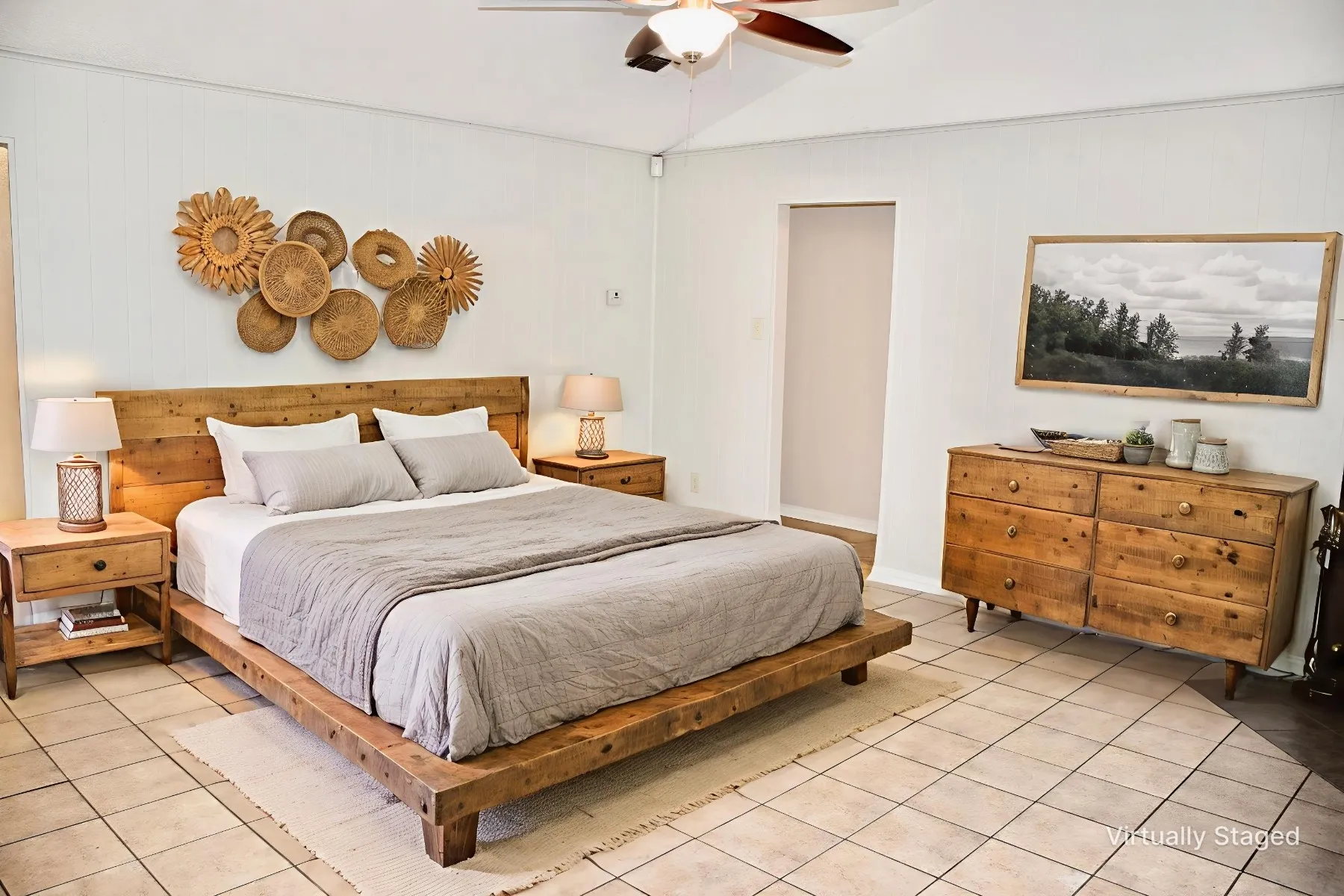 Spacious room featuring vaulted ceilings, a ceiling fan, and tile flooring