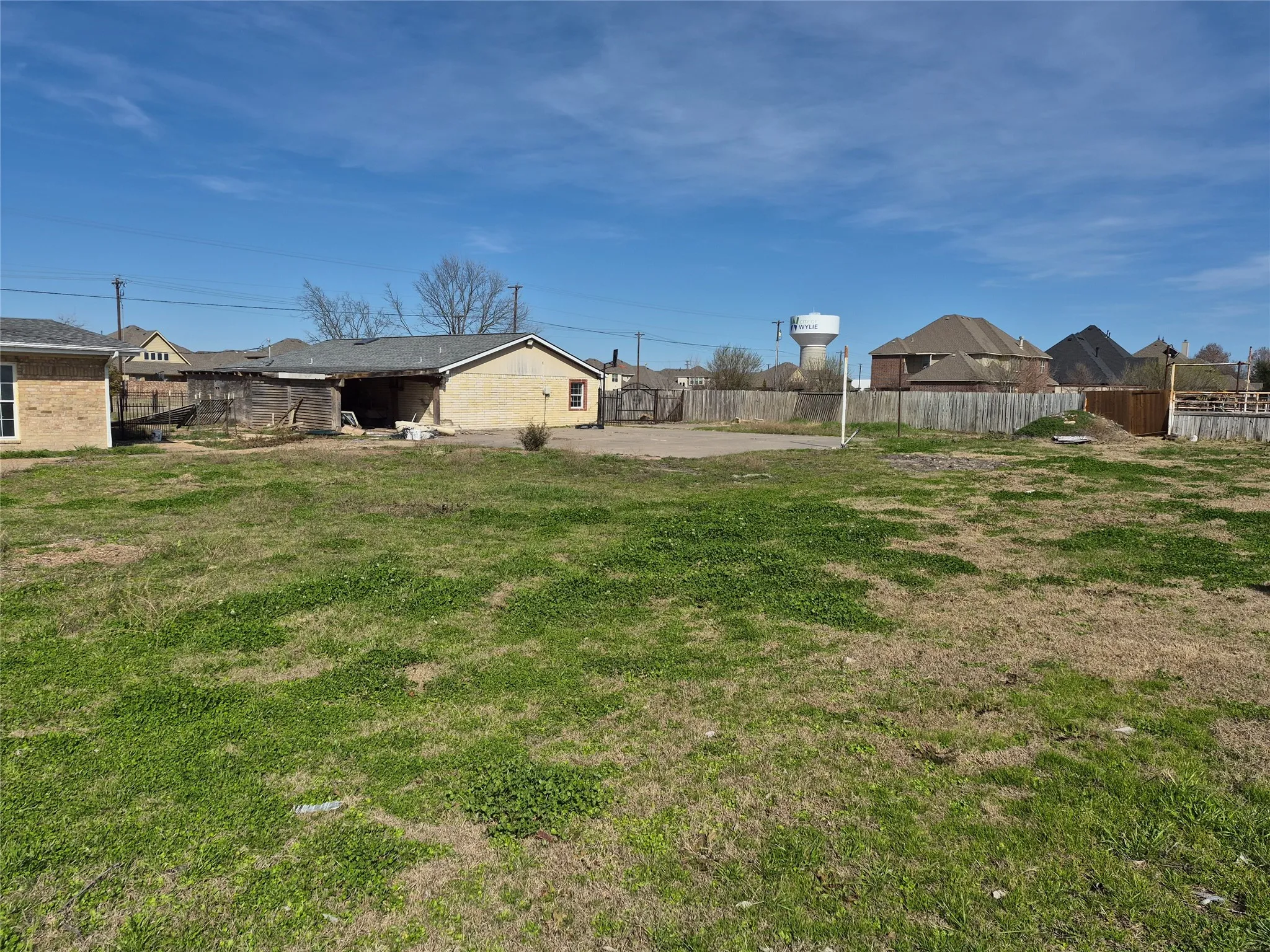 Expansive lot featuring a grassed area and a partially paved surface