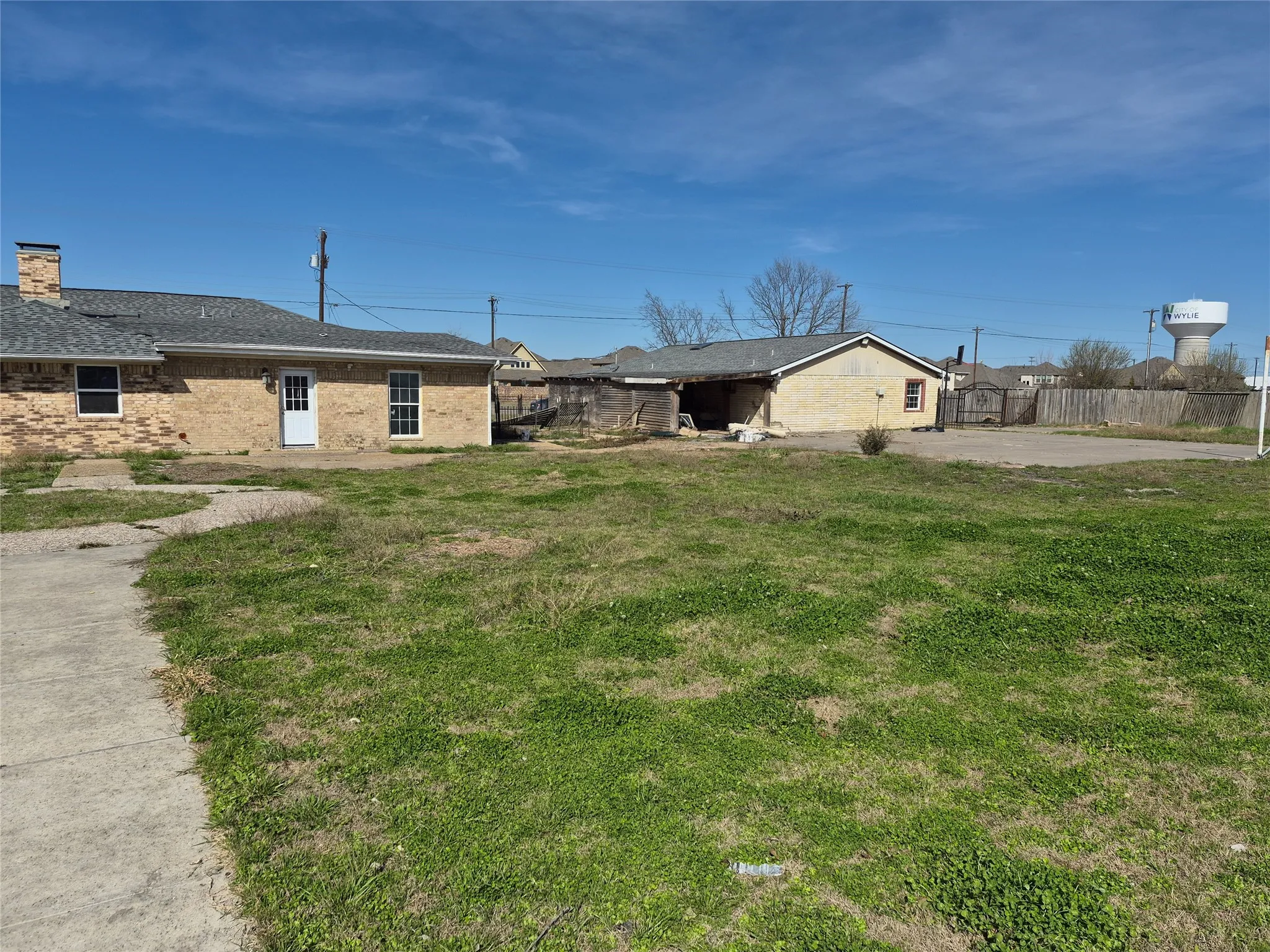 Brick exterior with a gabled roof and a concrete pathway