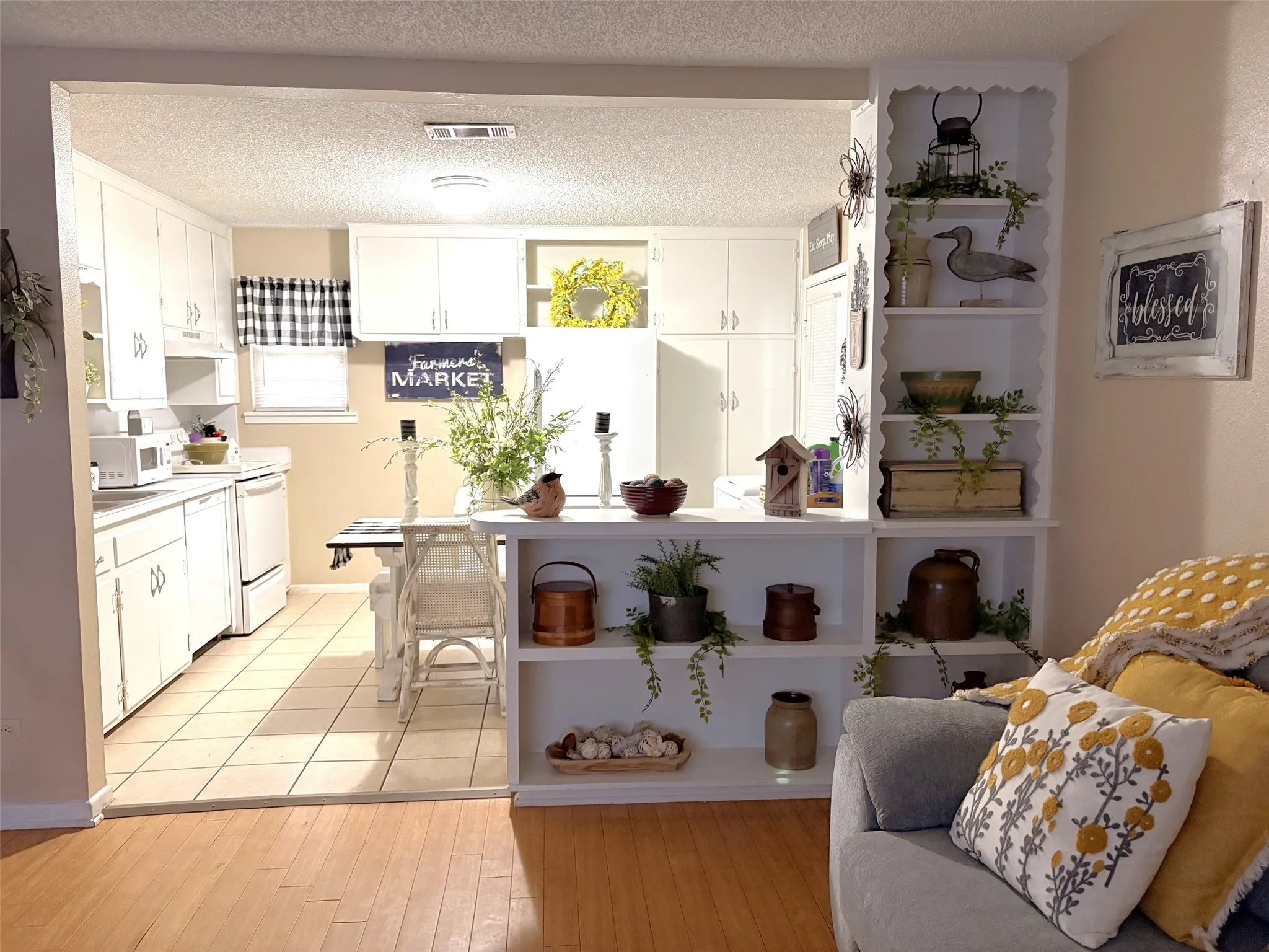 Kitchen featuring white cabinetry and light-toned countertops