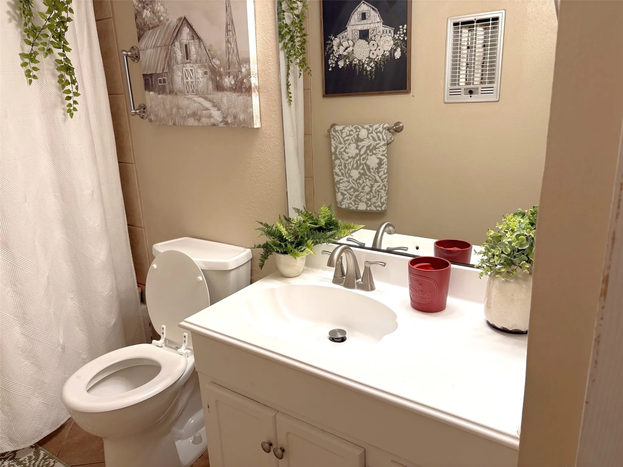 White vanity with integrated sink, brushed nickel faucet, and a wall-mounted mirror