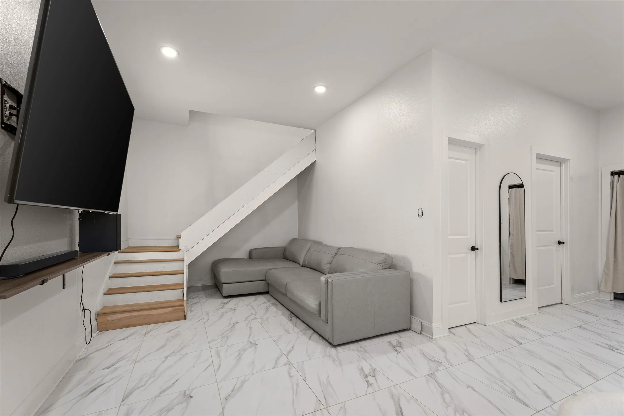 Bright interior space featuring large format marble-look tile flooring