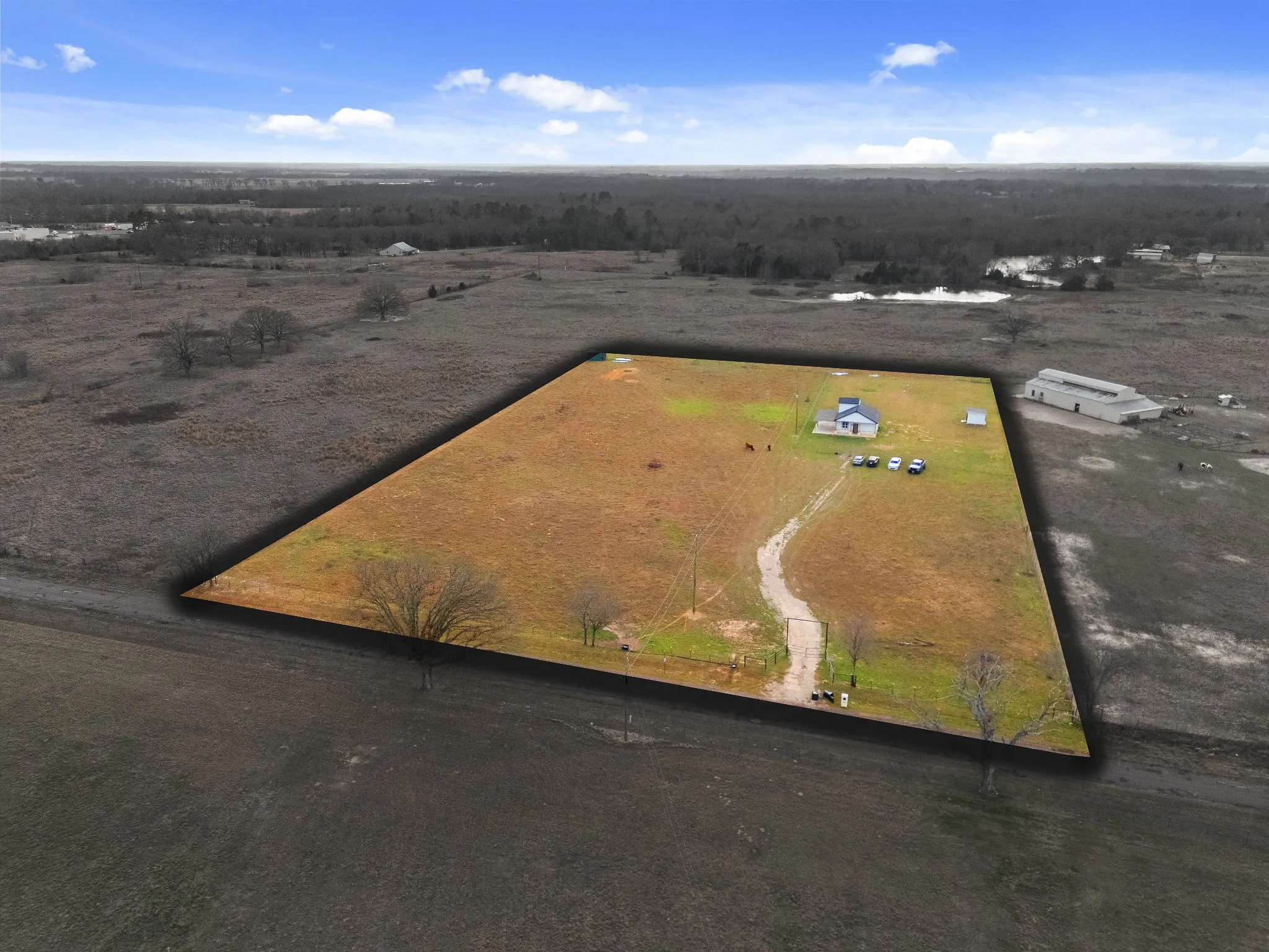 Expansive acreage with a single-story residence and outbuildings
