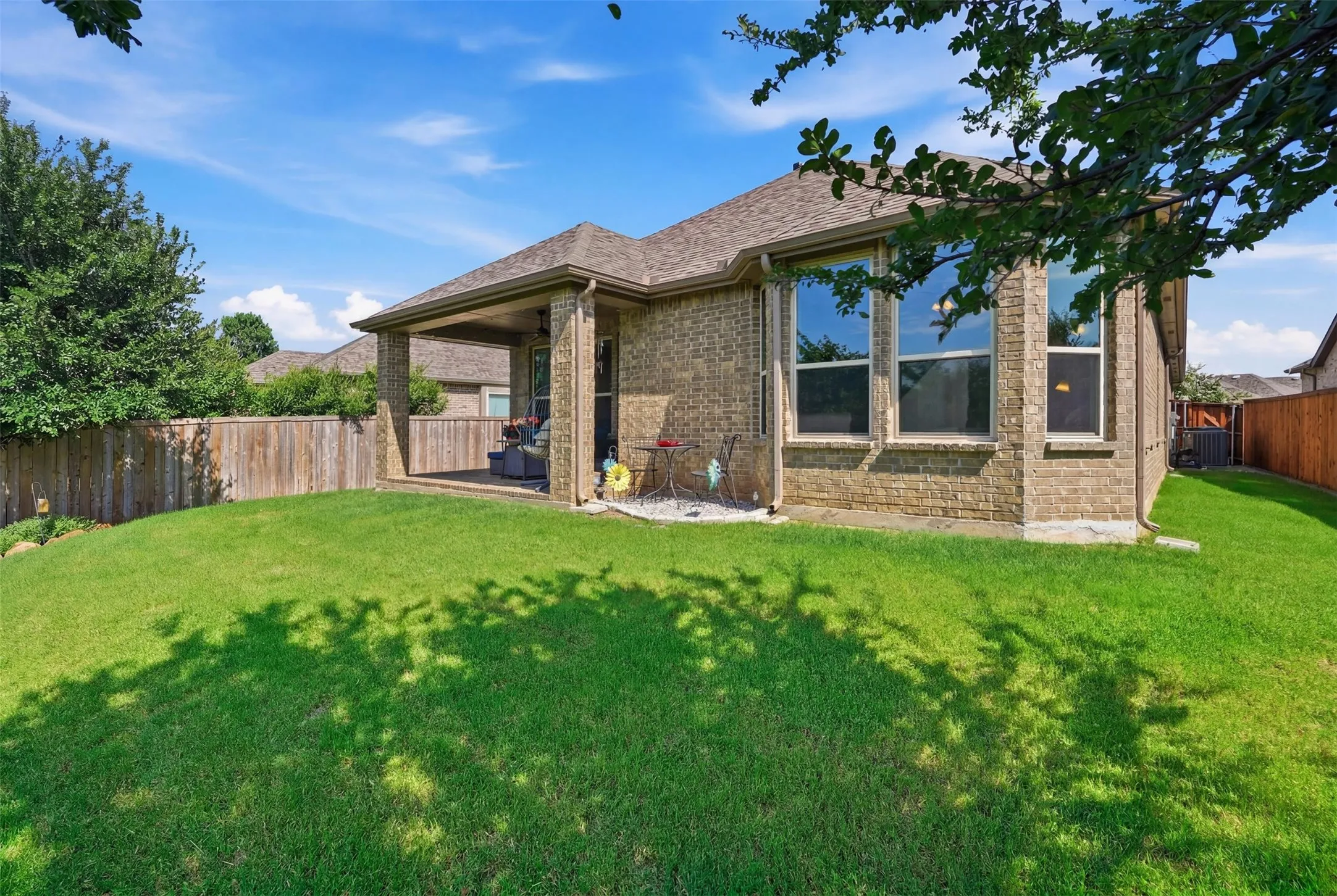 Enjoy peaceful outdoor living with a spacious backyard and covered patio.