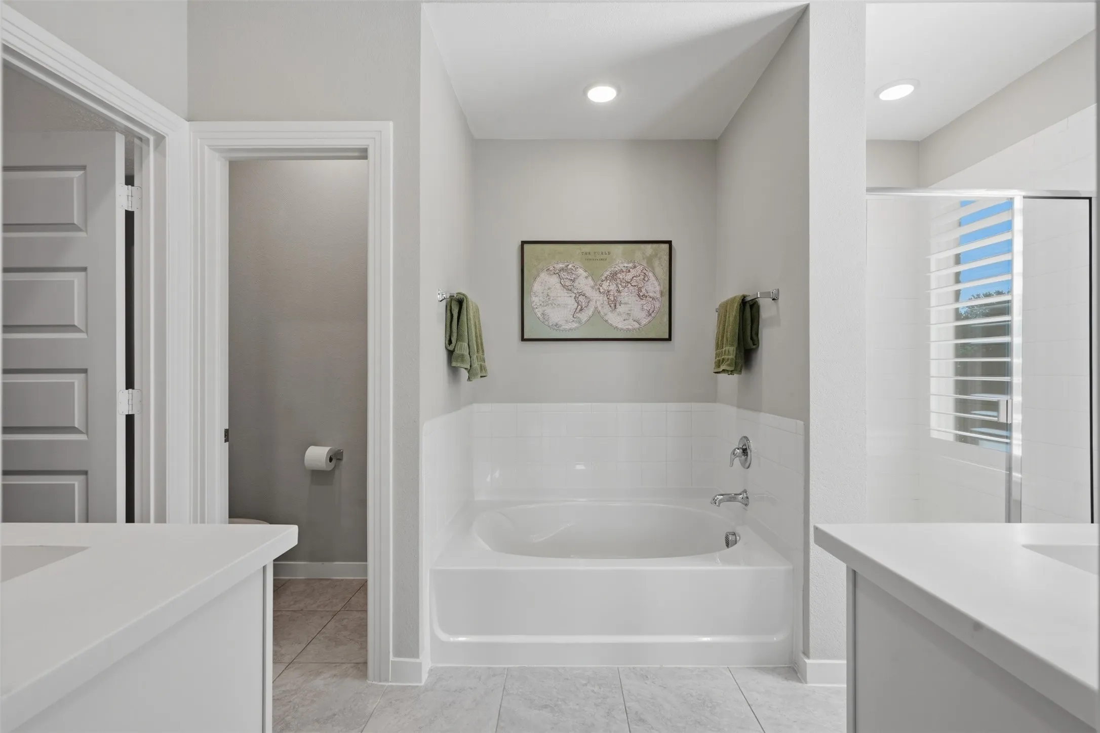 Elegant primary bathroom with a soaking tub and walk-in shower.
