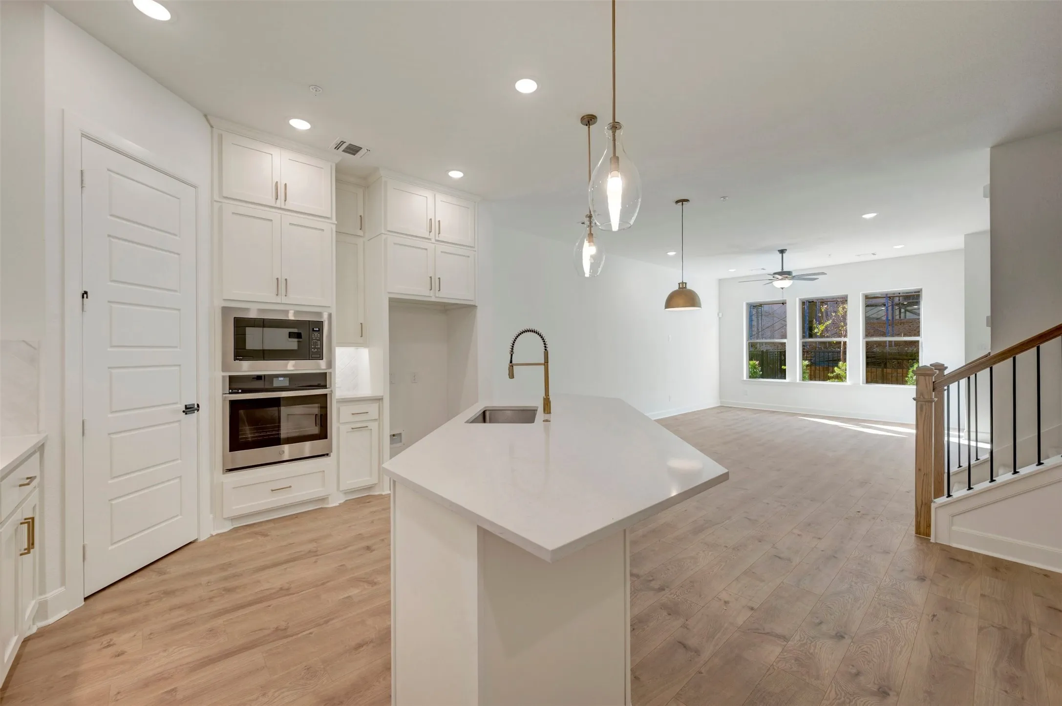 Gourmet kitchen with white cabinetry and stainless steel appliances