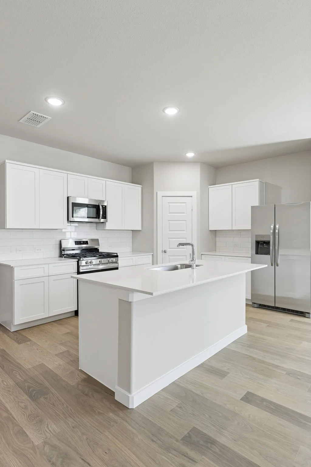 Kitchen in the Holden home plan by Trophy Signature Homes – REPRESENTATIVE PHOTO