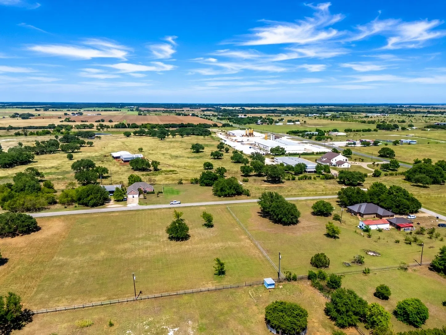 Expansive rural landscape featuring scattered residences and mature trees