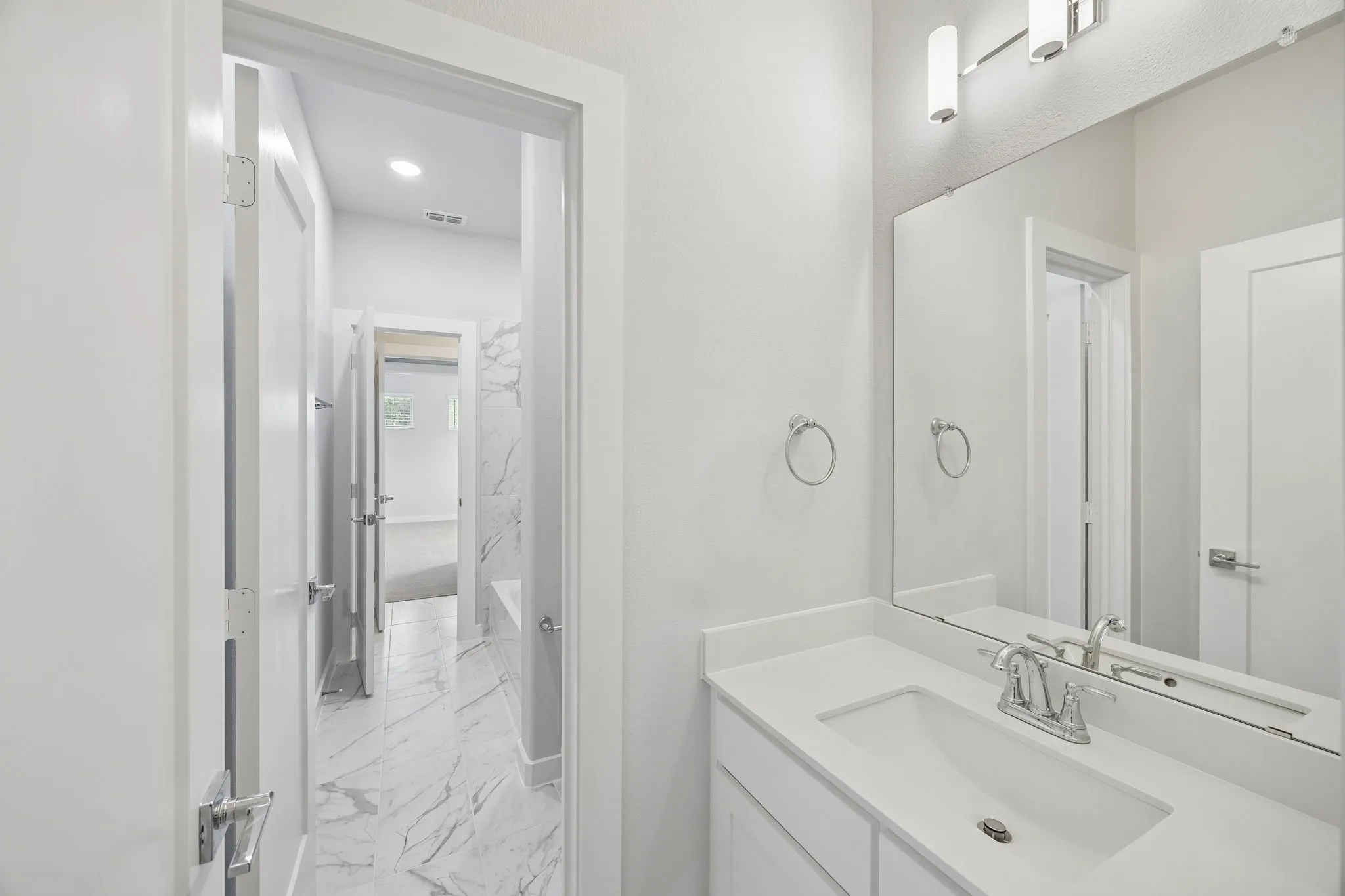 Dual Entry Bathroom in the Picasso II home plan by Trophy Signature Homes – REPRESENTATIVE PHOTO