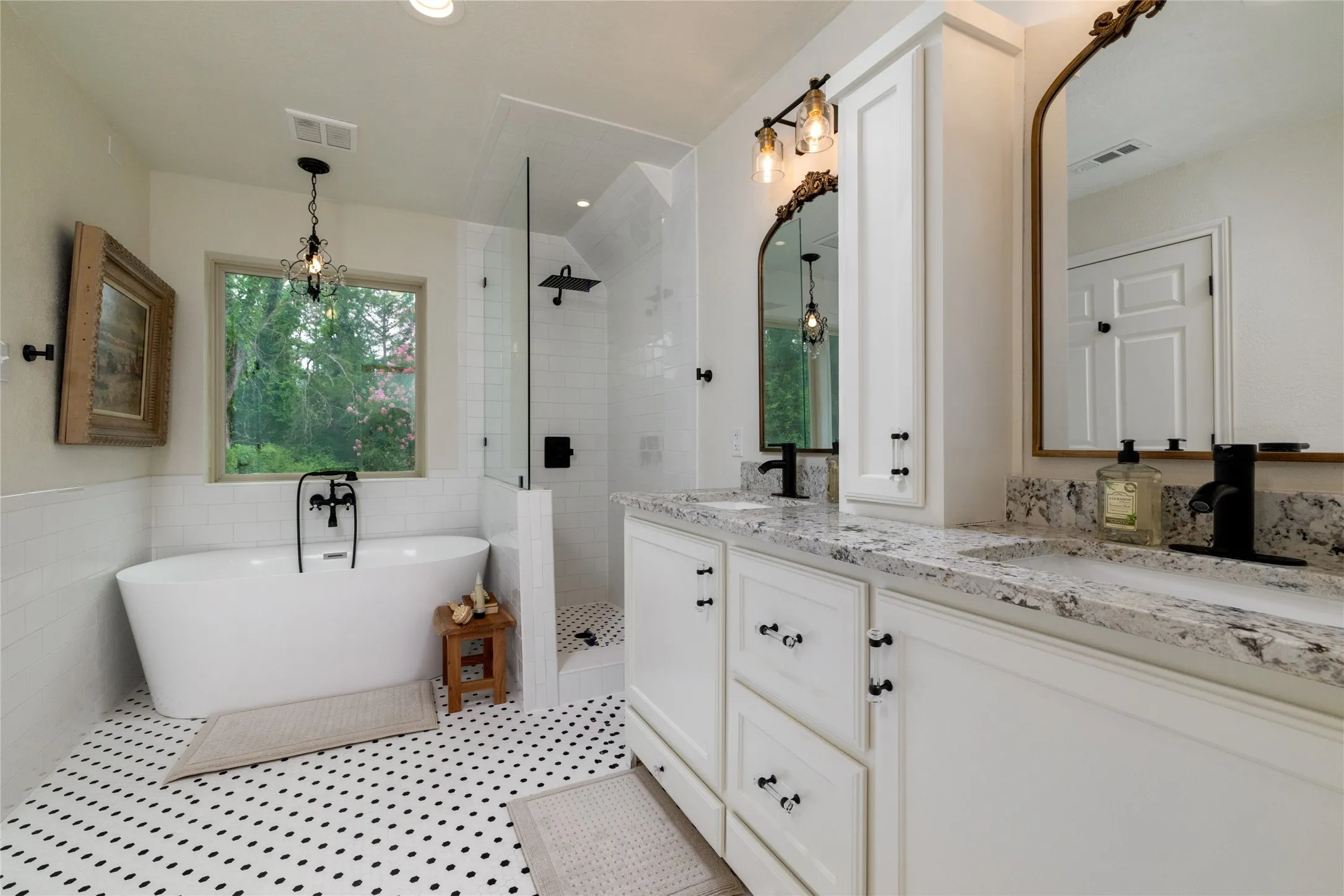 The Primary Suite Bathroom is one of three full baths that have been updated with high end, yet practical, touches.