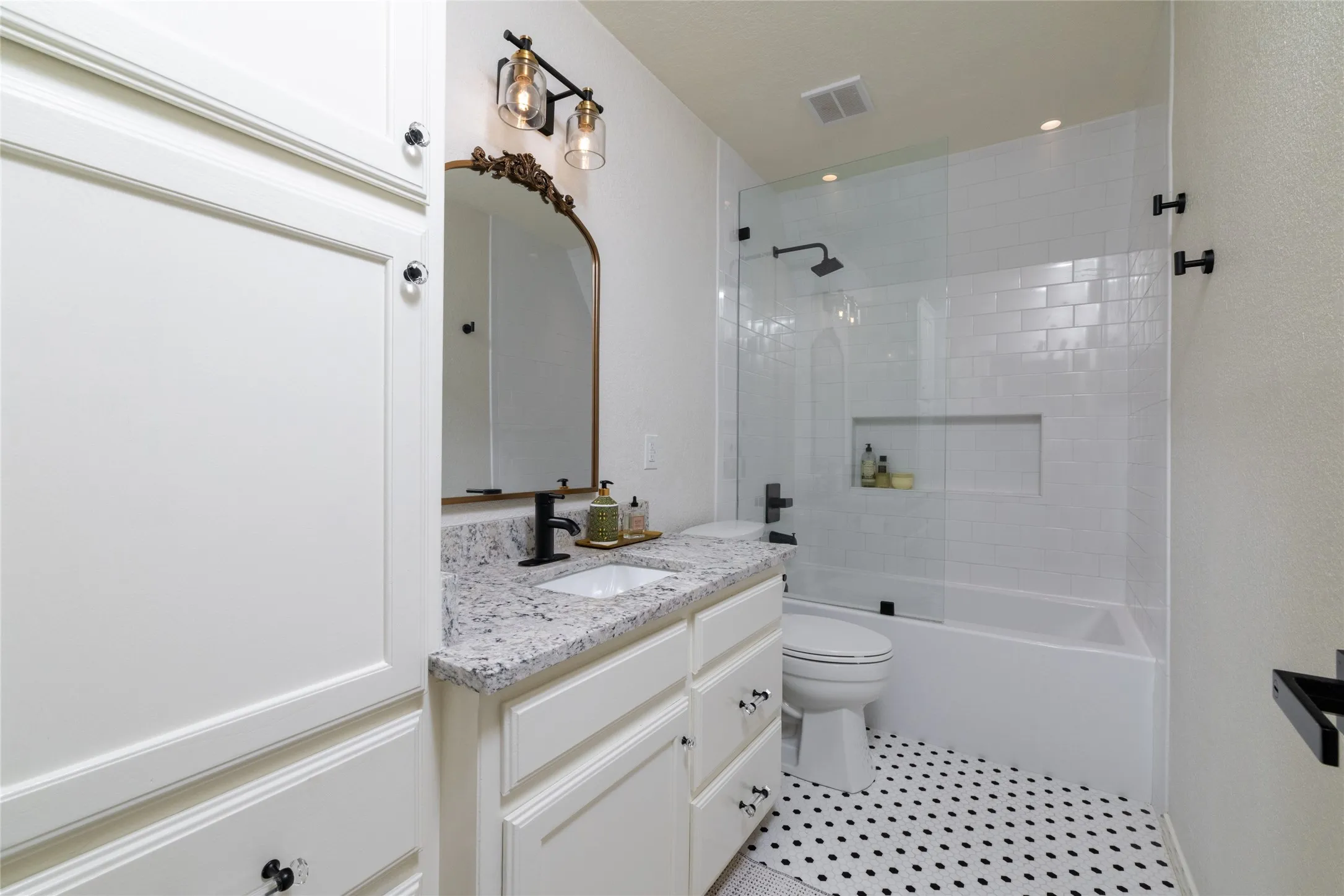 The Hall Bath, on the main floor, is one of three updated full baths.