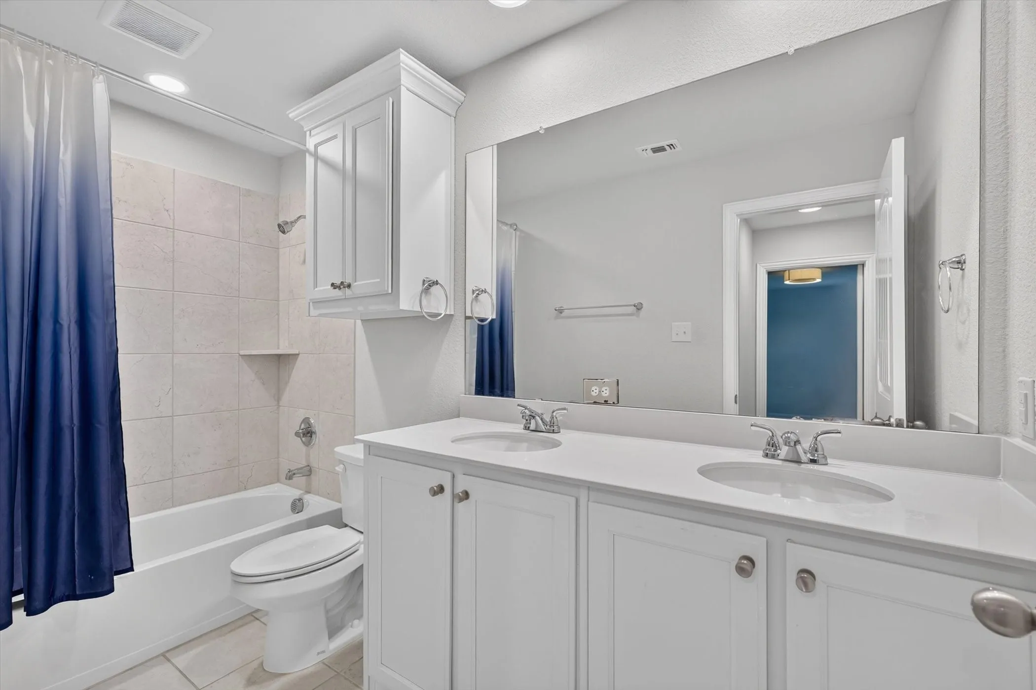 White double vanity with integrated sinks and chrome fixtures