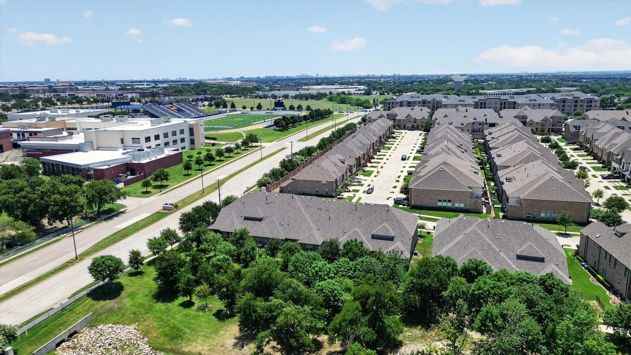Aerial overview showcasing multiple residential buildings with varied rooflines and surrounding green spaces